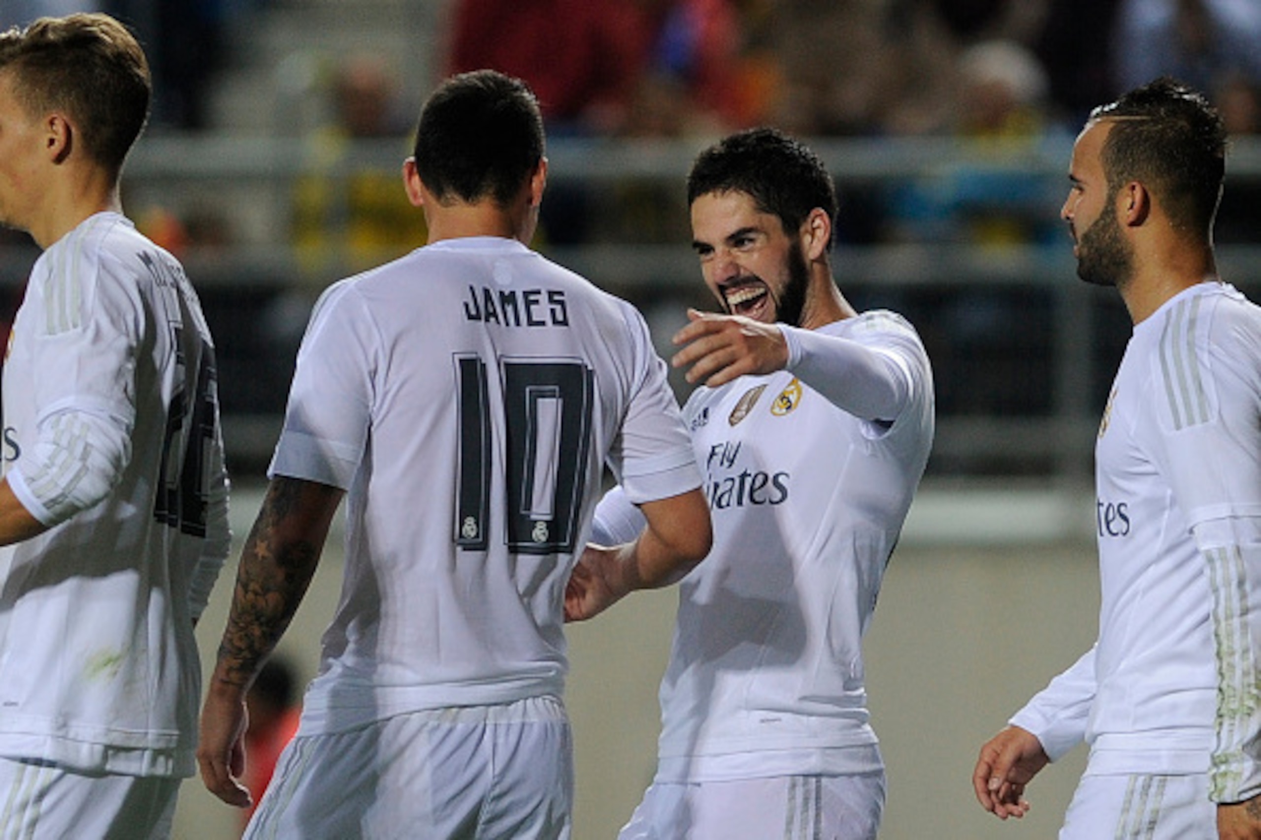 Real Madrid's midfielder Isco (2R) celebrates after scoring with Real Madrid's Colombian midfielder James Rodriguez (2L) during the Spanish Copa del Rey (King's Cup) football match Cadiz CF vs Real Madrid at the Ramon de Carranza in Cadiz on December 2, 2