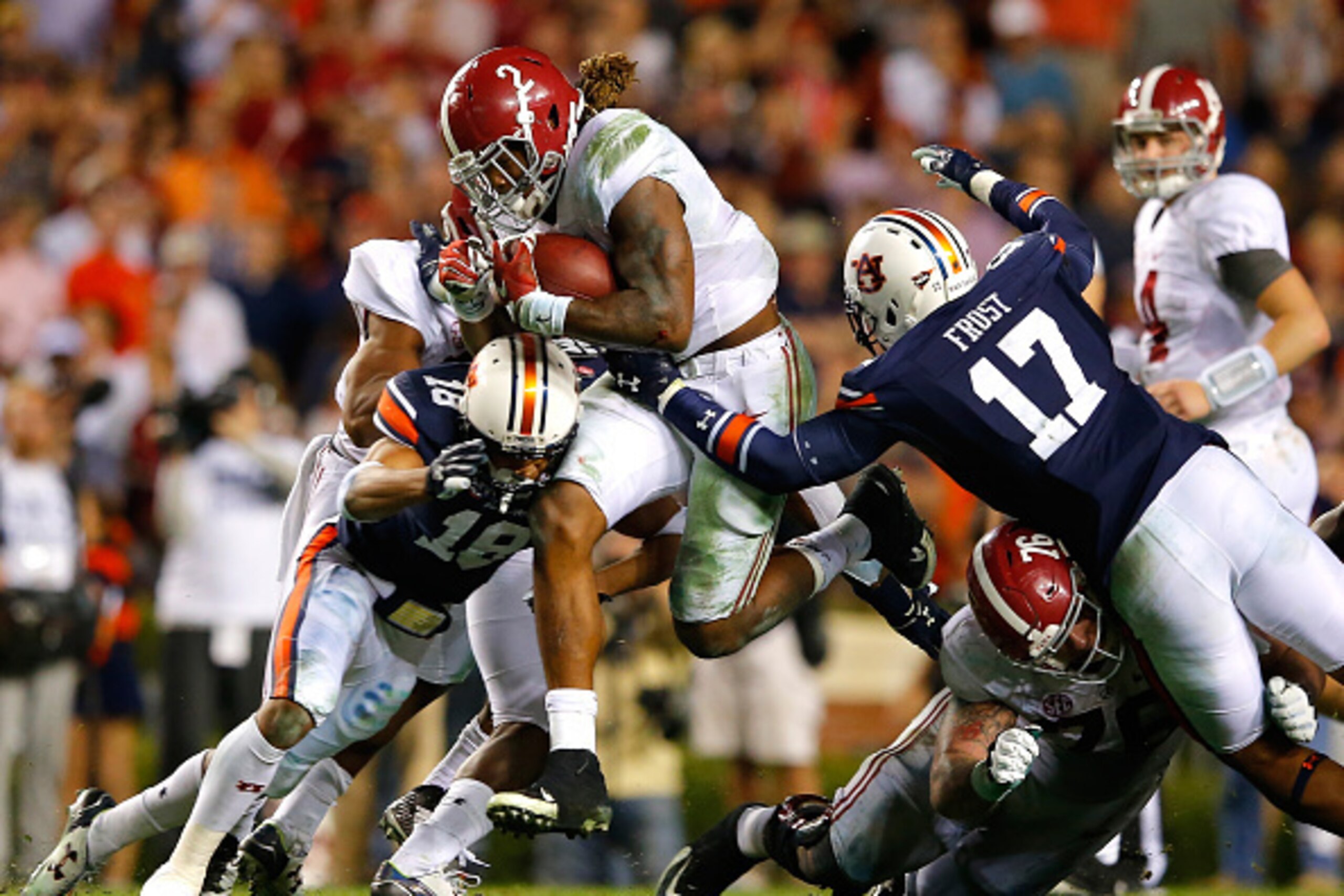 AUBURN, AL - NOVEMBER 28: Derrick Henry #2 of the Alabama Crimson Tide rushes against Carlton Davis #18 and Kris Frost #17 of the Auburn Tigers at Jordan Hare Stadium on November 28, 2015 in Auburn, Alabama. (Photo by Kevin C. Cox/Getty Images) AUBURN, AL - NOVEMBER 28: Derrick Henry #2 of the Alabama Crimson Tide rushes against Carlton Davis #18 and Kris Frost #17 of the Auburn Tigers at Jordan Hare Stadium on November 28, 2015 in Auburn, Alabama. (Photo by Kevin C. Cox/Getty Images)
