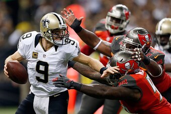 NEW ORLEANS, LA - SEPTEMBER 20:  Drew Brees #9 of the New Orleans Saints is sacked by Gerald McCoy #93 of the Tampa Bay Buccaneers during the first quarter of a game at the Mercedes-Benz Superdome on September 20, 2015 in New Orleans, Louisiana.  (Photo b