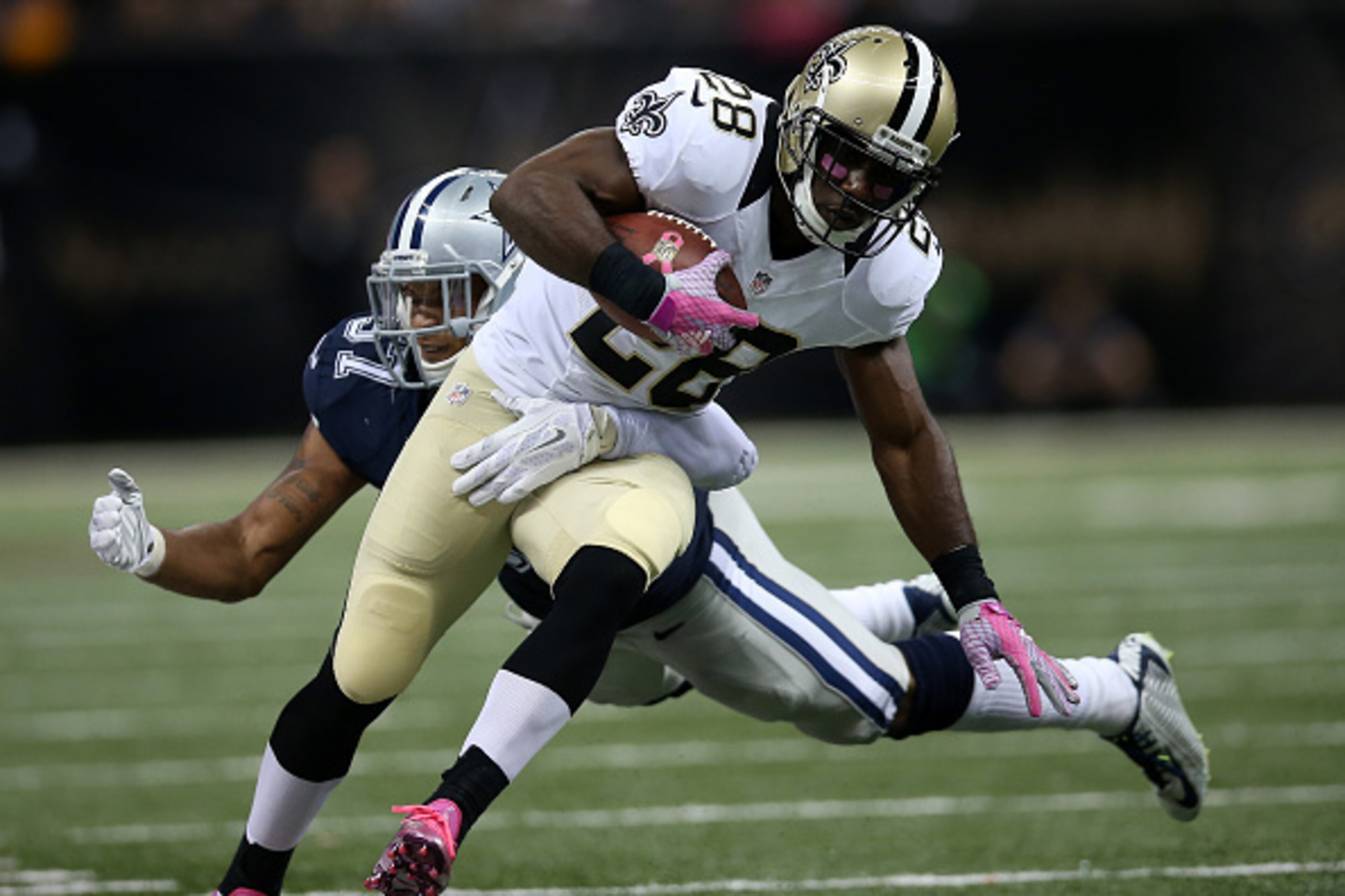 NEW ORLEANS, LA - OCTOBER 04:   C.J. Spiller #28 of the New Orleans Saints runs the ball for a first down during the fourth quarter against the Dallas Cowboys at Mercedes-Benz Superdome on October 4, 2015 in New Orleans, Louisiana.  (Photo by Chris Grayth