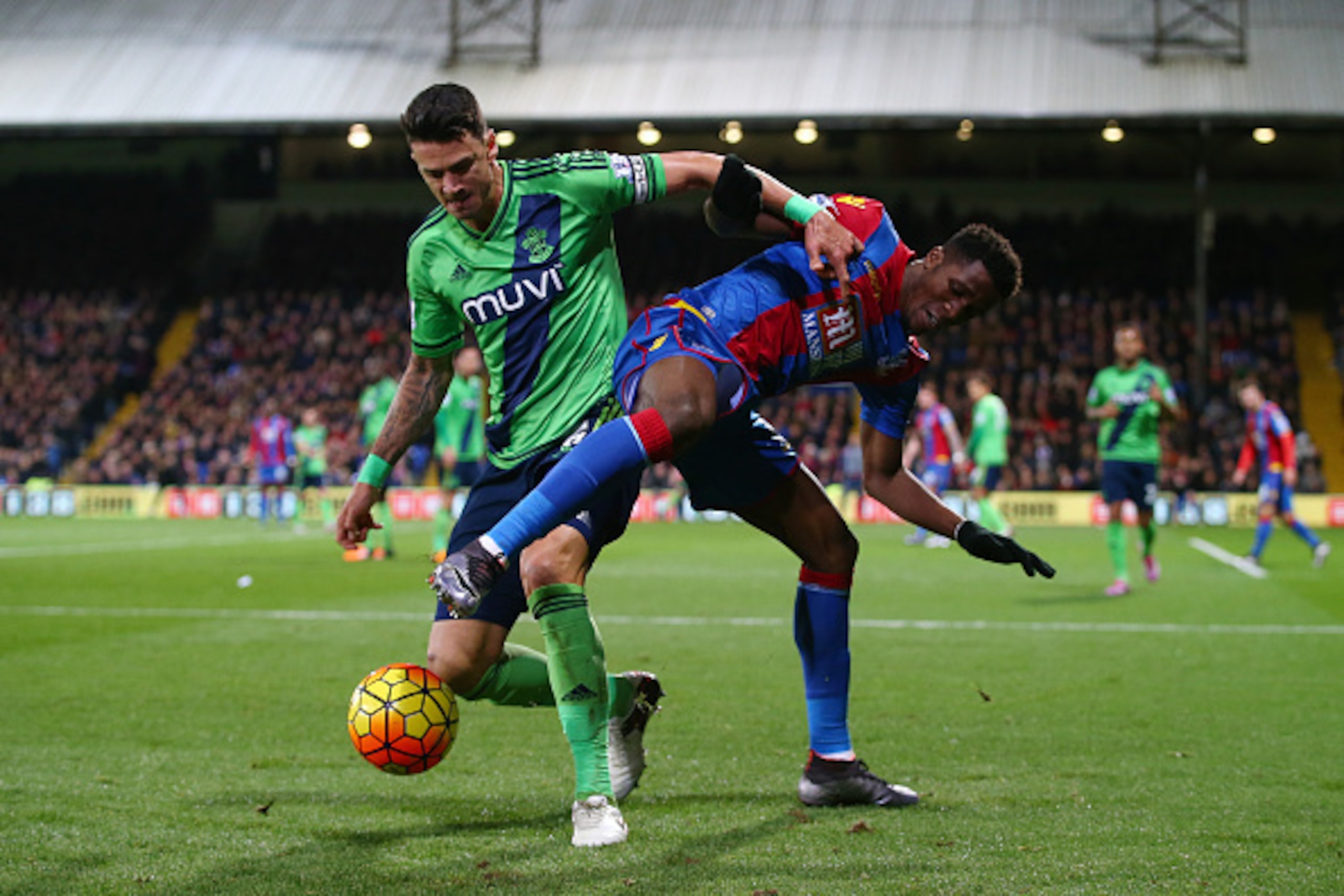 LONDON, ENGLAND - DECEMBER 12: Wilfried Zaha of Crystal Palace and Jose Fonte of Southampton compete for the ball  during the Barclays Premier League match between Crystal Palace and Southampton at Selhurst Park on December 12, 2015 in London, United King