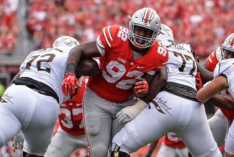 COLUMBUS, OH - SEPTEMBER 26:  Adolphus Washington #92 of the Ohio State Buckeyes breaks through the line against the Western Michigan Broncos at Ohio Stadium on September 26, 2015 in Columbus, Ohio.   (Photo by Jamie Sabau/Getty Images)