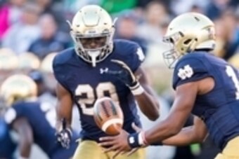 Oct 10, 2015; South Bend, IN, USA; Notre Dame Fighting Irish quarterback DeShone Kizer (14) pitches the ball to running back C.J. Prosise (20) in the third quarter against the Navy Midshipmen at Notre Dame Stadium. Notre Dame won 41-24. Mandatory Credit: 