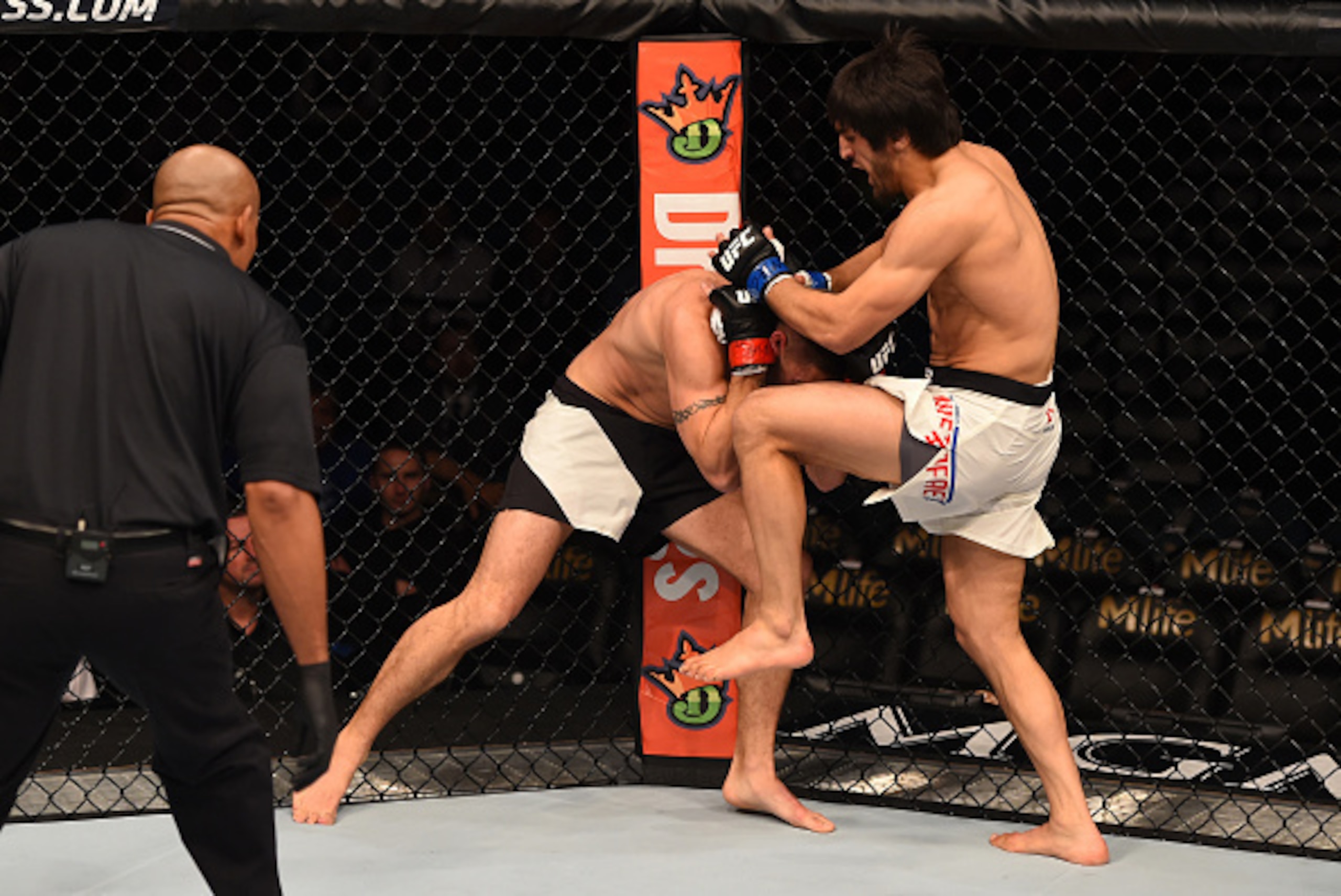 LAS VEGAS, NV - DECEMBER 12: (R-L) Magomed Mustafaev of Russia knees Joe Proctor in their lightweight bout during the UFC 194 event inside MGM Grand Garden Arena on December 12, 2015 in Las Vegas, Nevada.  (Photo by Josh Hedges/Zuffa LLC/Zuffa LLC via Get