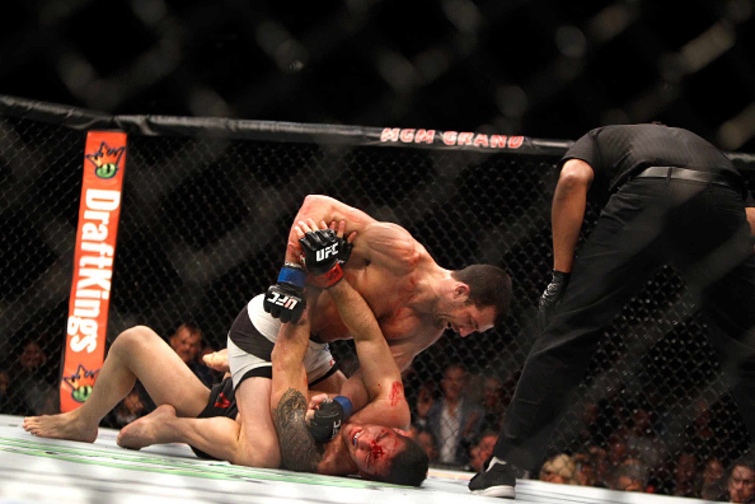 LAS VEGAS, NV - DECEMBER 12: Luke Rockhold (top) punches Chris Weidman in their middleweight title fight during UFC 194 on December 12, 2015 in Las Vegas, Nevada. Rockhold took the title with a fourth-round TKO.  (Photo by Steve Marcus/Getty Images)