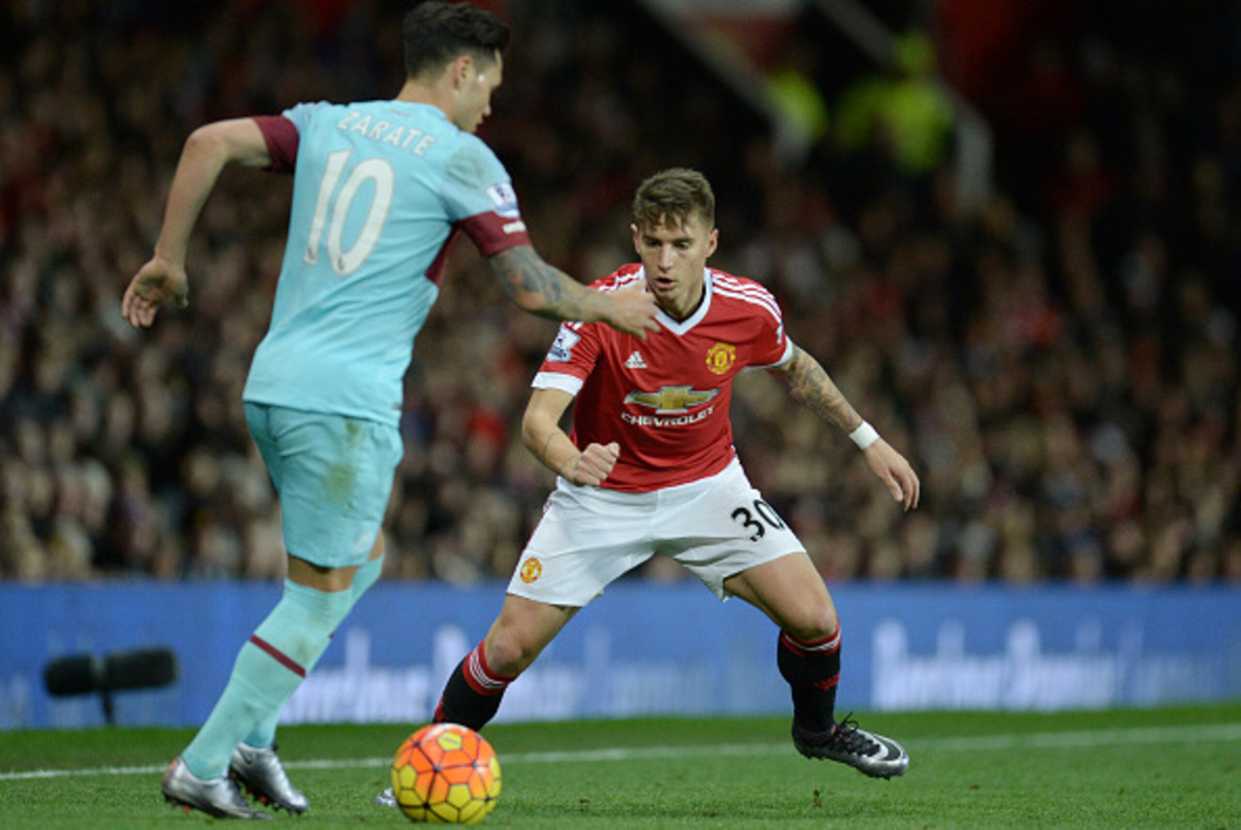 West Ham United's Argentinian striker Mauro Zarate (L) vies with Manchester United's Uruguayan defender Guillermo Varela during the English Premier League football match between Manchester United and West Ham United at Old Trafford in Manchester, north we