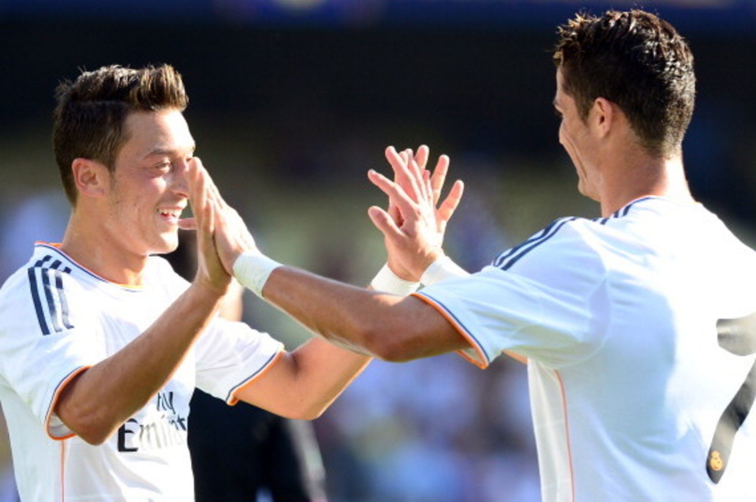 Mesut Ozil (L) of Real Madrid celebrates with teammate Cristiano Ronaldo after Ozil scored against Everton during first half action in their International Champions Cup match at Dodger Stadium in Los Angeles on August 3, 2013.   AFP PHOTO/Frederic J. BROW