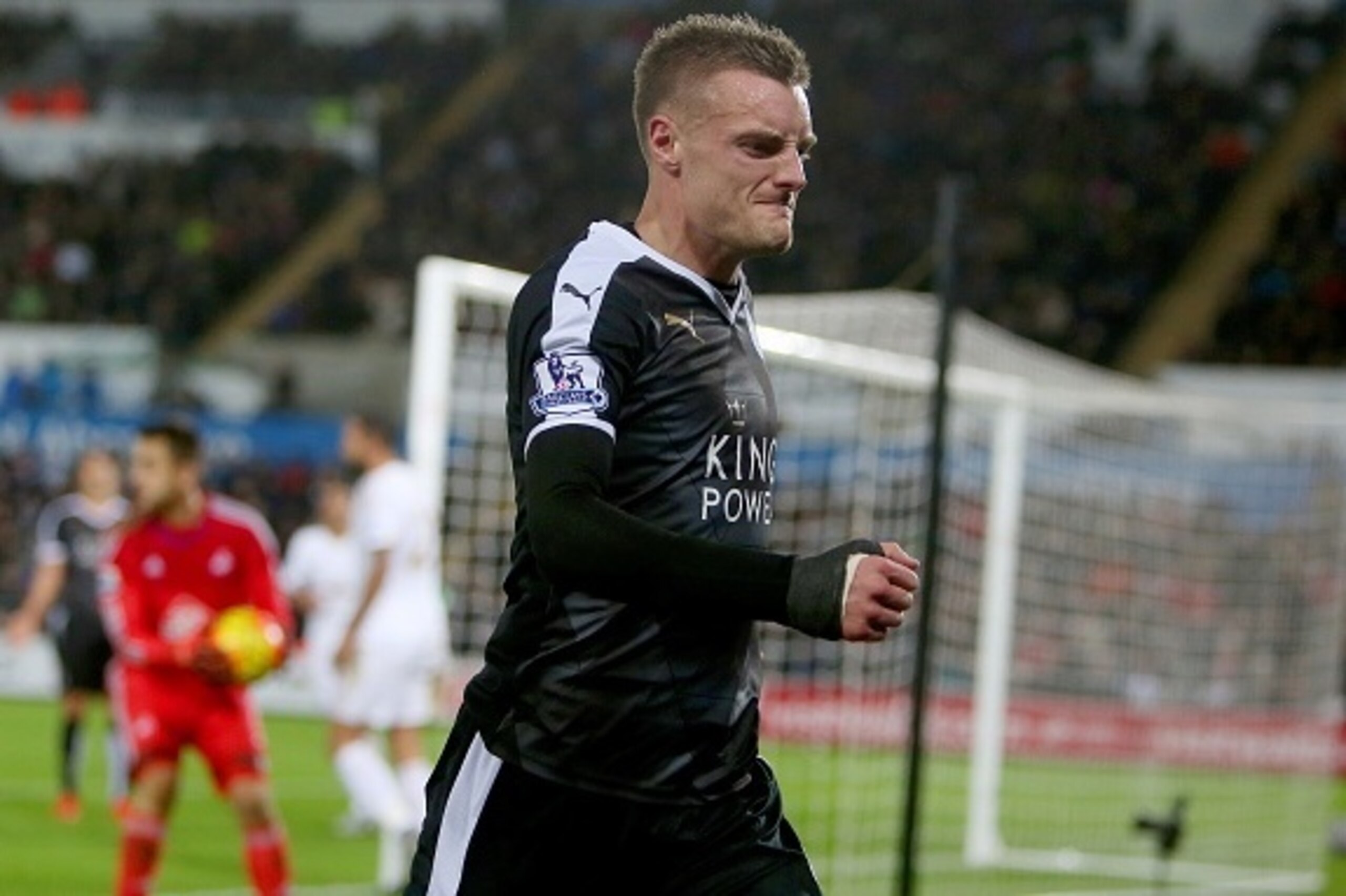 Leicester City's English striker Jamie Vardy kicks the advertising boards in frustration after missing a goal opportunity during the English Premier League football match between Swansea City and Leicester City at The Liberty Stadium in Swansea, south Wal