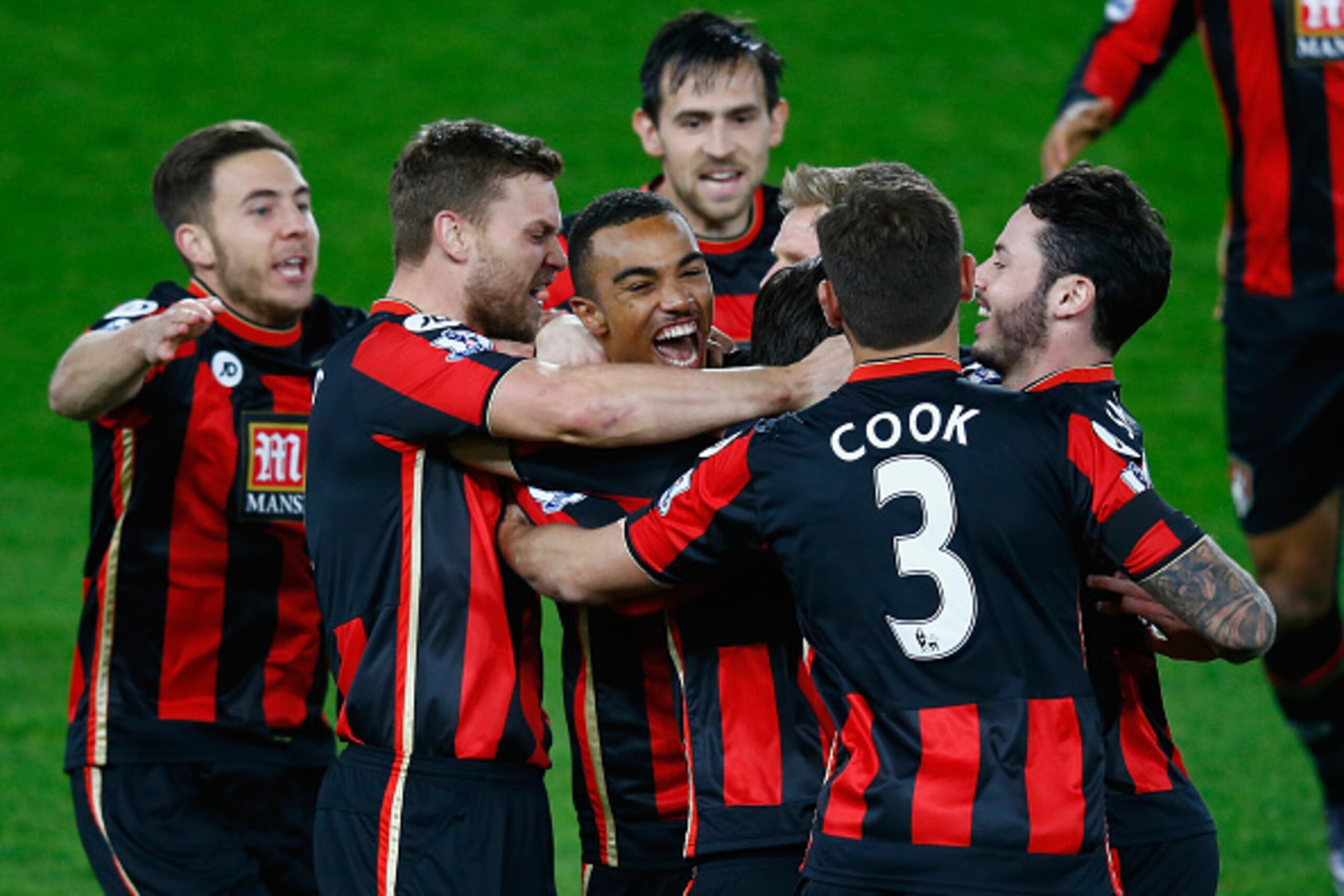 BOURNEMOUTH, ENGLAND - DECEMBER 12:  Junior Stanislas of Bournemouth celebrates scoring their first goal with his team mates during the Barclays Premier League match between A.F.C. Bournemouth and Manchester United at the Vitality Stadium on December 12, 
