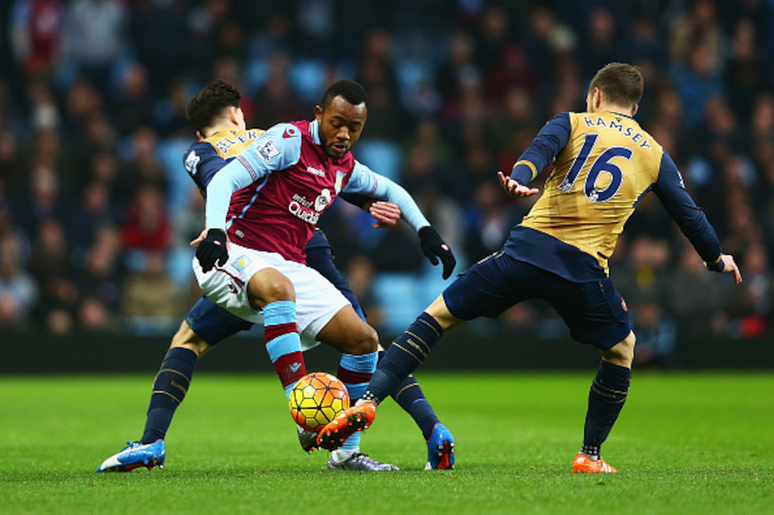 BIRMINGHAM, ENGLAND - DECEMBER 13:  Jordan Ayew of Aston Villa is challenged by Aaron Ramsey of Arsenal during the Barclays Premier League match between Aston Villa and Arsenal at Villa Park on December 13, 2015 in Birmingham, England.  (Photo by Clive Ma