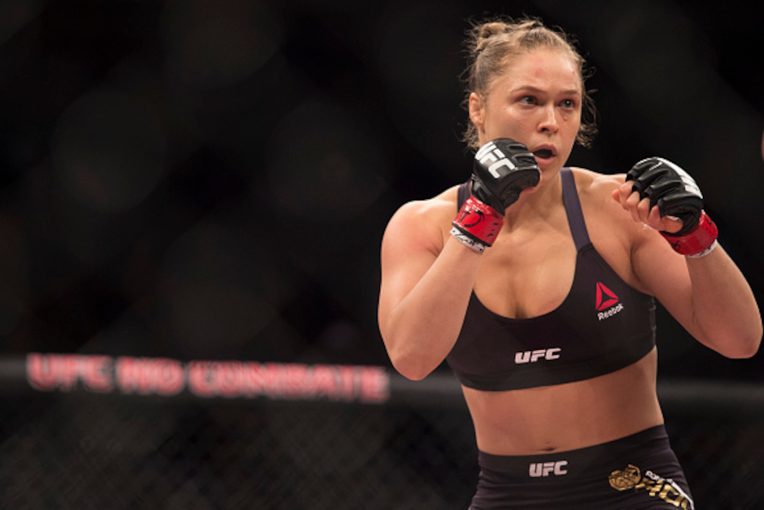 RIO DE JANEIRO, BRAZIL - AUGUST 01:  UFC women's bantamweight champion Ronda Rousey of the United States rushes forward against Bethe Correia of Brazil during the UFC 190 event inside HSBC Arena on August 1, 2015 in Rio de Janeiro, Brazil.  (Photo by Jeff