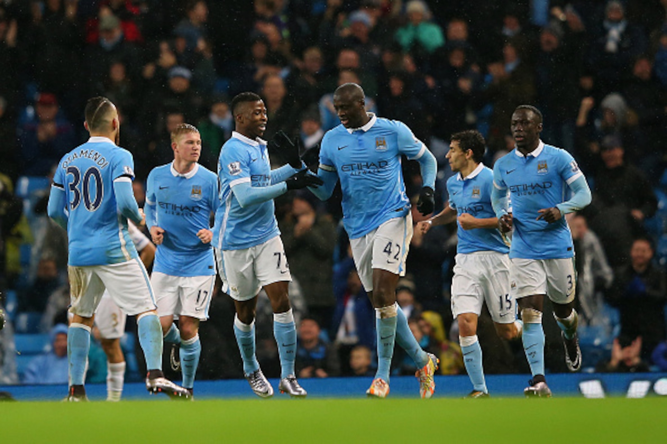 MANCHESTER, ENGLAND - DECEMBER 12:  Yaya Toure (3rd R) of Manchester City celebrates his team's second goal with his team mates during the Barclays Premier League match between Manchester City and Swansea City at Etihad Stadium on December 12, 2015 in Man