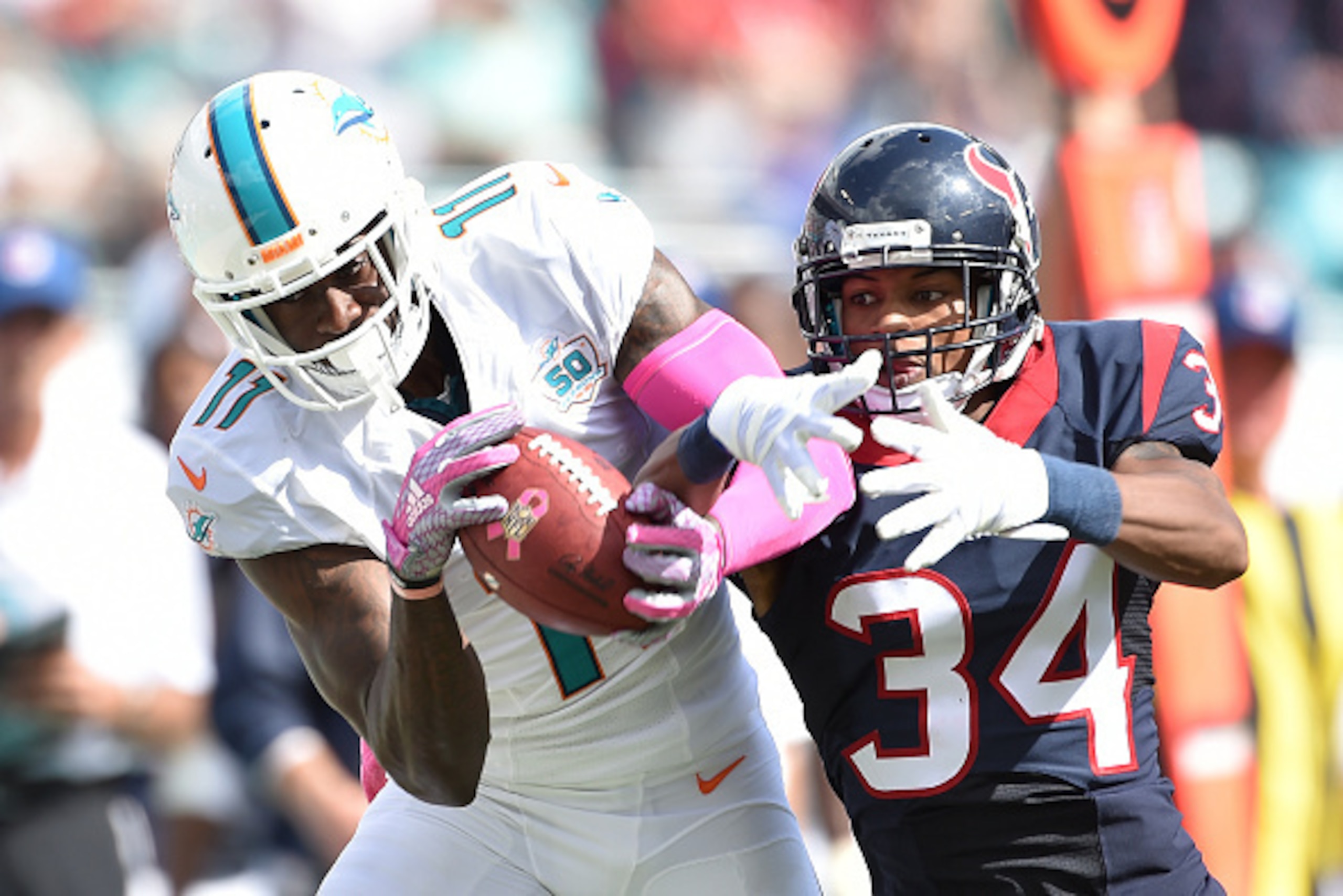 MIAMI GARDENS, FL - OCTOBER 25: Wide receiver DeVante Parker #11 of the Miami Dolphins catches a pass as A.J. Bouye #34 of the Houston Texans defends during a NFL game against the Miami Dolphins at Sun Life Stadium on October 25, 2015 in Miami Gardens, MIAMI GARDENS, FL - OCTOBER 25: Wide receiver DeVante Parker #11 of the Miami Dolphins catches a pass as A.J. Bouye #34 of the Houston Texans defends during a NFL game against the Miami Dolphins at Sun Life Stadium on October 25, 2015 in Miami Gardens,