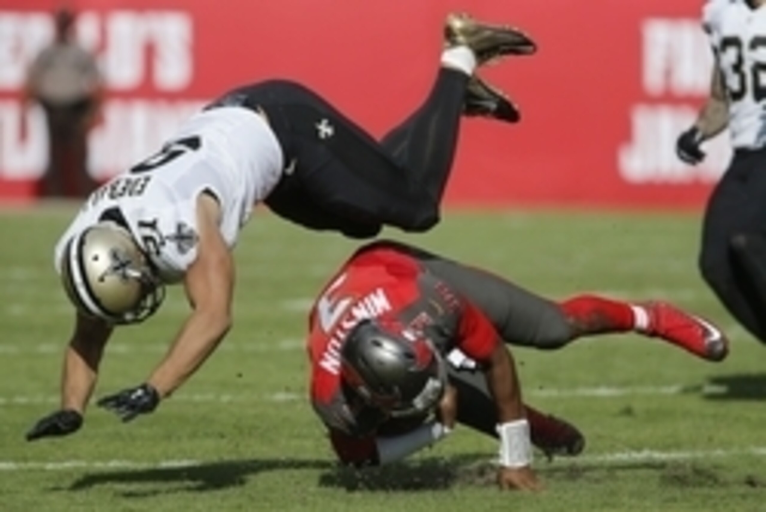 Dec 13, 2015; Tampa, FL, USA; New Orleans Saints outside linebacker Kasim Edebali (91) dives over Tampa Bay Buccaneers quarterback Jameis Winston (3) who slid after a run during the second quarter of an NFL football game at Raymond James Stadium. Mandator