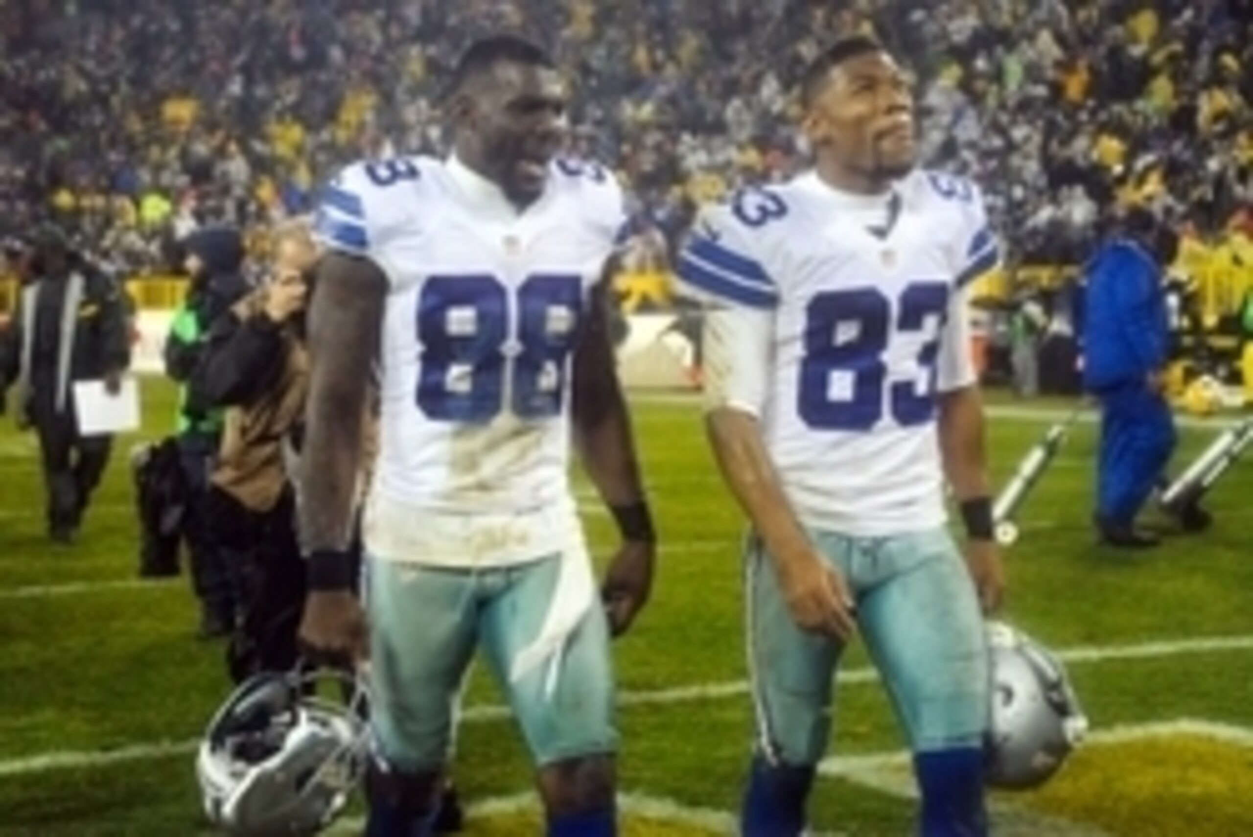 Dec 13, 2015; Green Bay, WI, USA;  Dallas Cowboys wide receiver Dez Bryant (88) and wide receiver Terrance Williams (83) walk off the field after losing to the Green Bay Packers 28-7 at Lambeau Field. Mandatory Credit: Benny Sieu-USA TODAY Sports