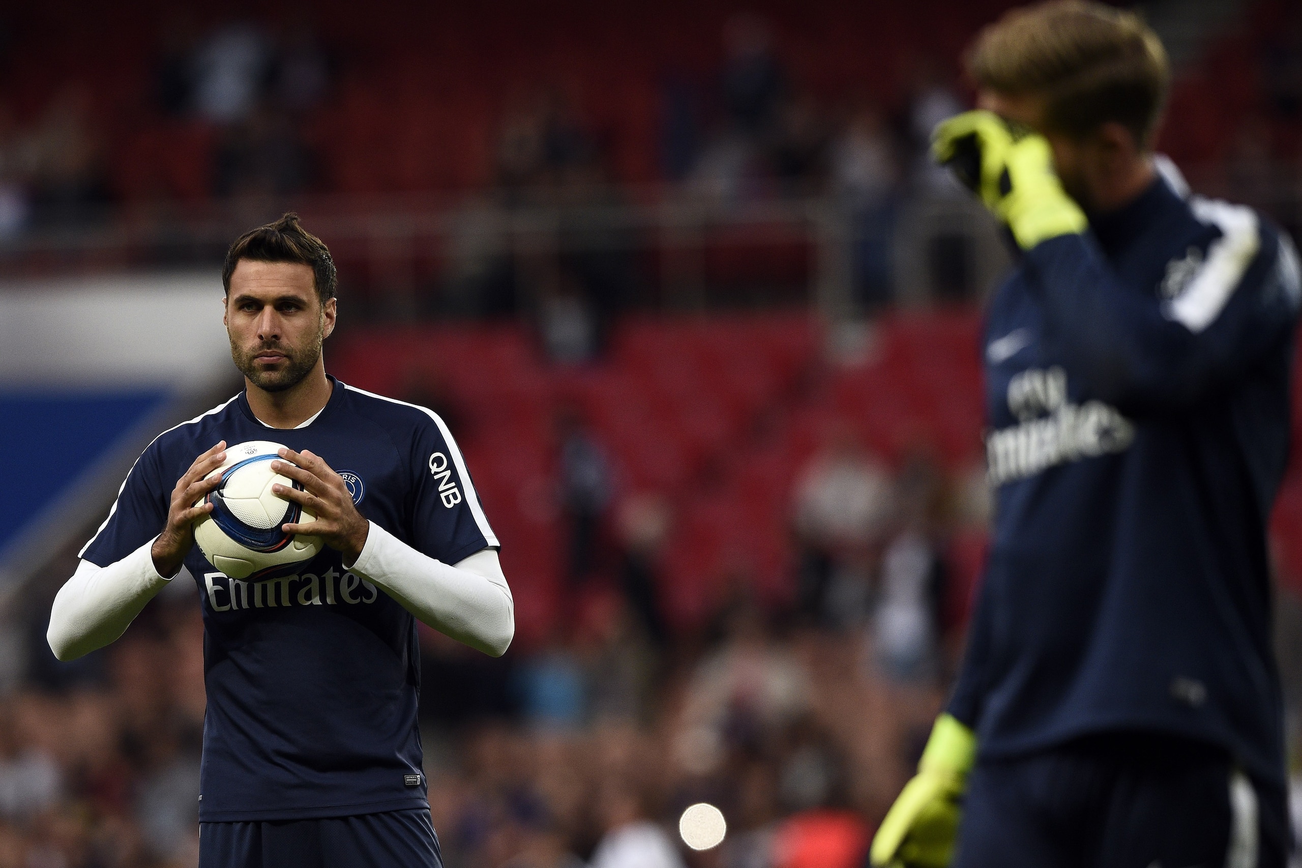 Paris Saint-Germain's German goalkeeper Kevin Trapp (R) and Paris Saint-Germain's Italian goalkeeper Salvatore Sirigu warm up before the French L1 football match Paris Saint-Germain FC vs GFC Ajaccio on August 16, 2015 at the Parc des Princes in Paris.  A