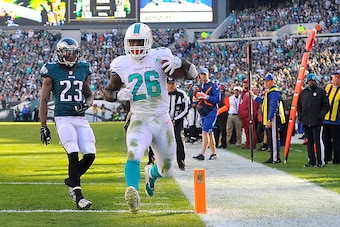 PHILADELPHIA, PA - NOVEMBER 15:  Lamar Miller #26 of the Miami Dolphins scores a second quarter touchdown reception against Nolan Carroll #23 of the Philadelphia Eagles at Lincoln Financial Field on November 15, 2015 in Philadelphia, Pennsylvania.  (Photo