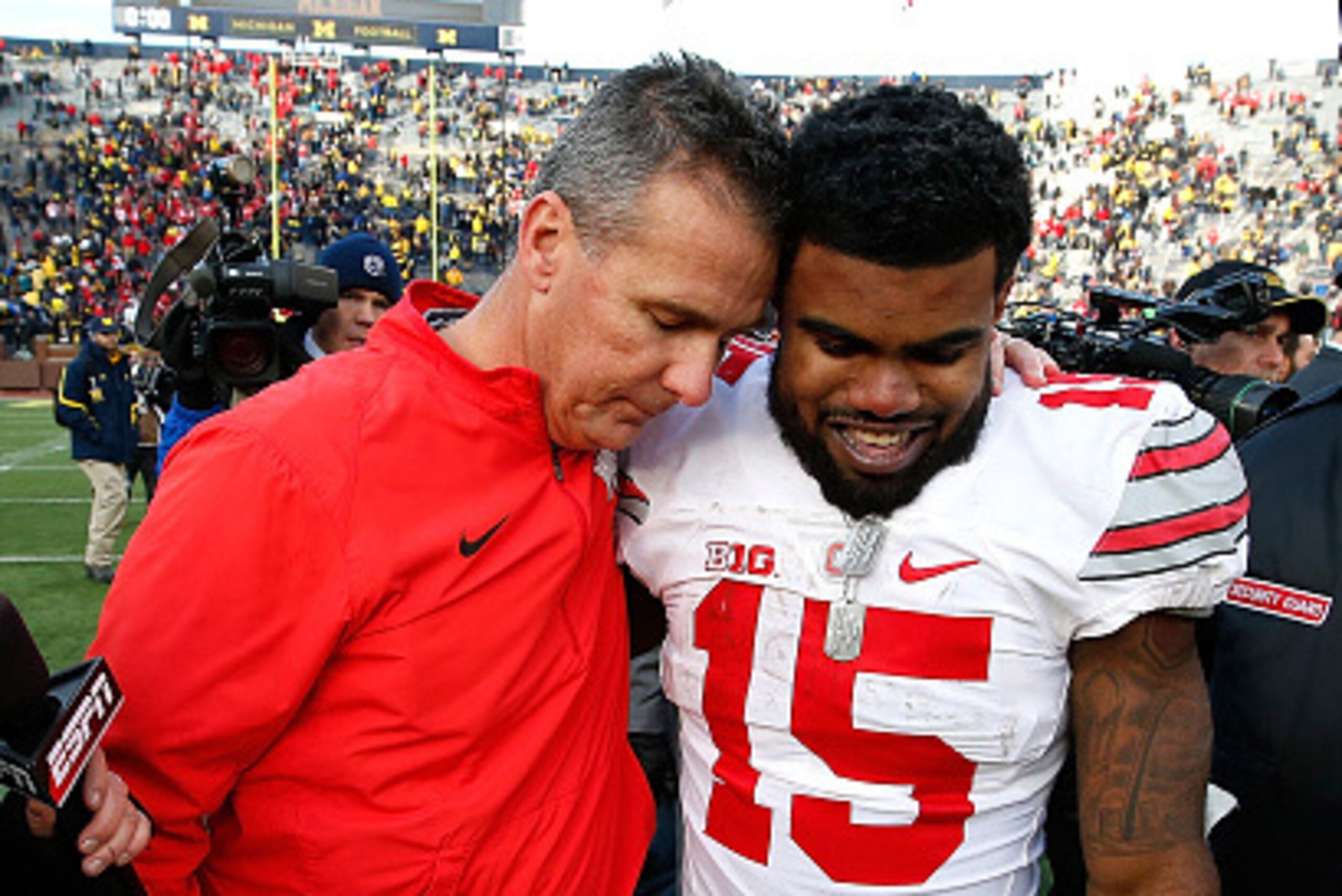 ANN ARBOR, MI - NOVEMBER 28:  Head coach Urban Meyer of the Ohio State Buckeyes celebrates with Ezekiel Elliott #15 after a 42-13 Ohio State win over the Michigan Wolverines at Michigan Stadium on November 28, 2015 in Ann Arbor, Michigan.  (Photo by Grego