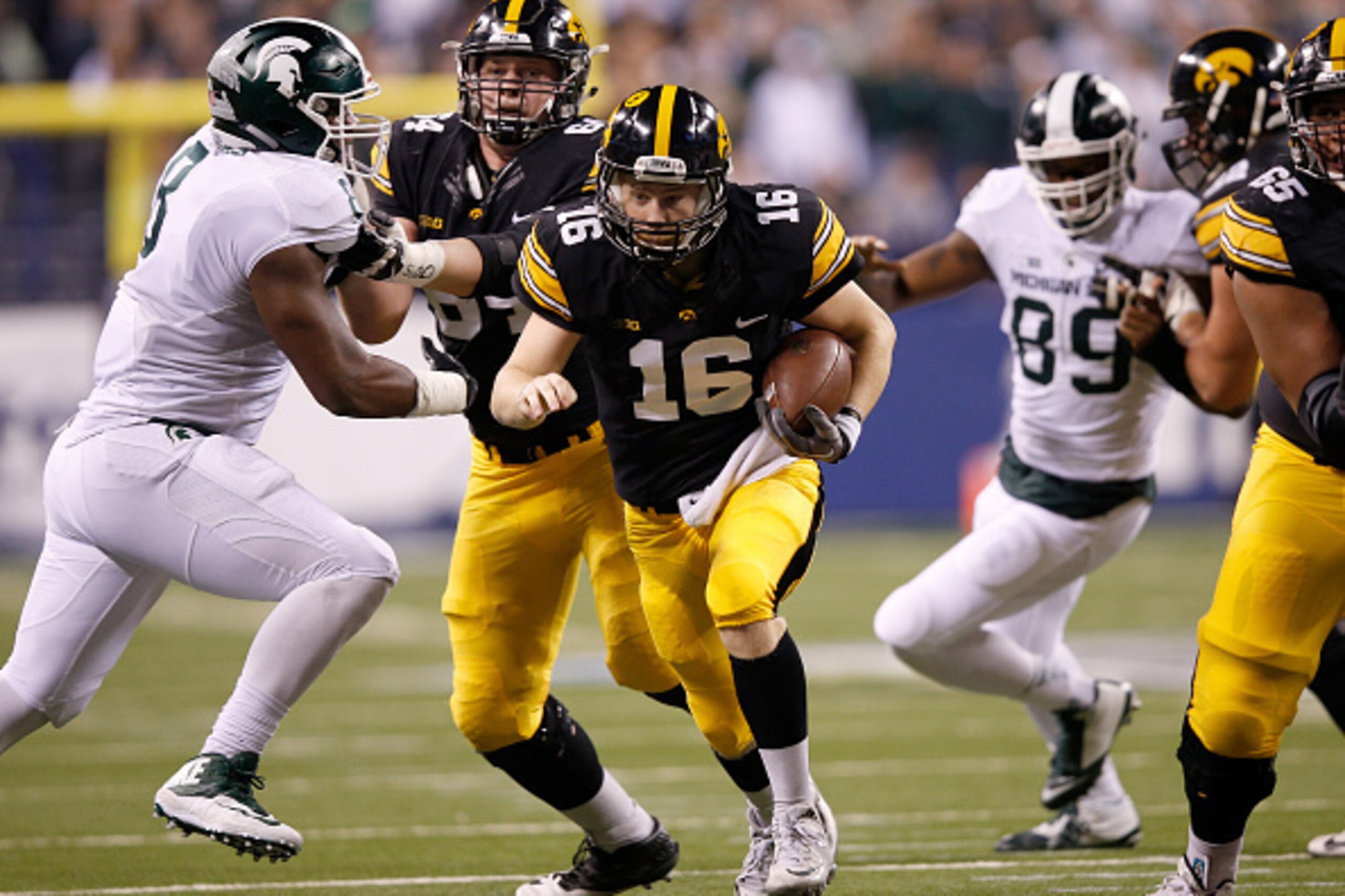 INDIANAPOLIS, IN - DECEMBER 05:  C.J. Beathard #16 of the Iowa Hawkeyes scrambles against the Michigan State Spartans in the Big Ten Championship at Lucas Oil Stadium on December 5, 2015 in Indianapolis, Indiana.  (Photo by Joe Robbins/Getty Images)