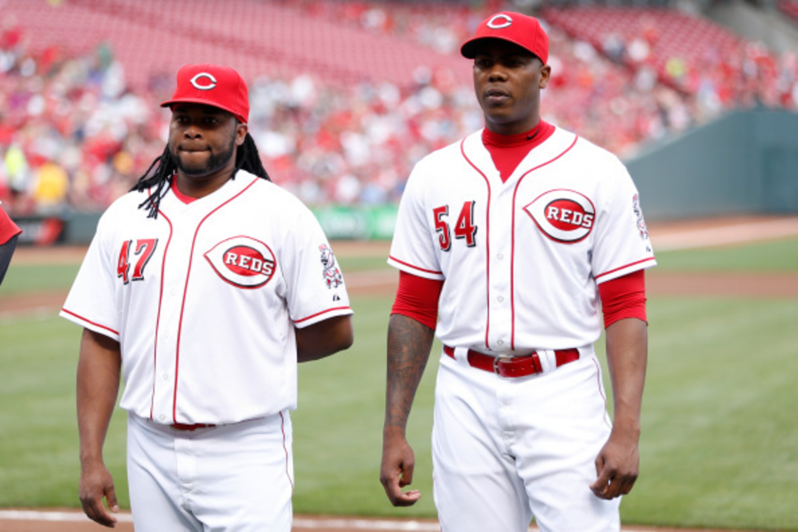 CINCINNATI, OH - AUGUST 6: Johnny Cueto #47 and Aroldis Chapman #54 of the Cincinnati Reds look on before the game against the Cleveland Indians at Great American Ball Park on August 6, 2014 in Cincinnati, Ohio. The Reds won 8-3. (Photo by Joe Robbins/Get