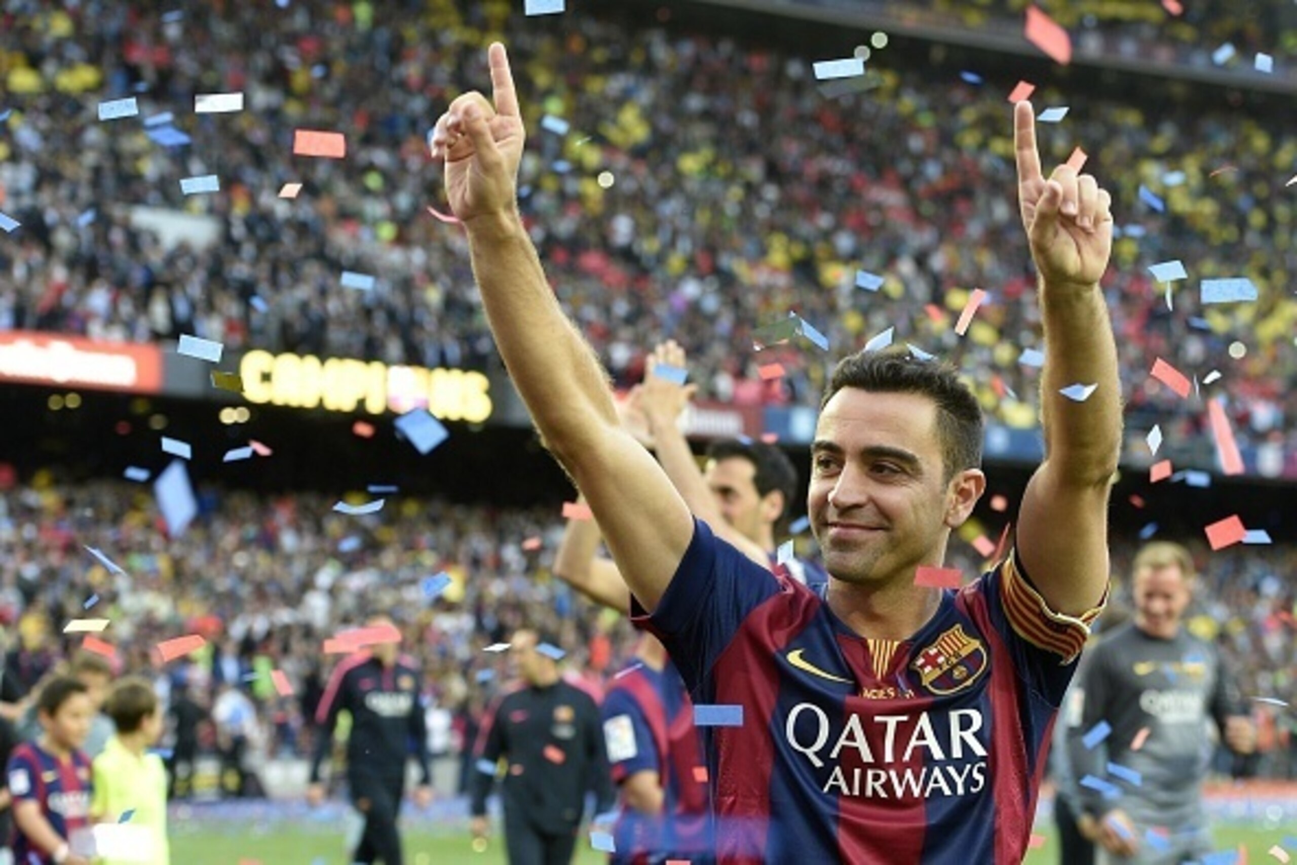 Barcelona's midfielder Xavi Hernandez celebrates after the Spanish league football match FC Barcelona vs RC Deportivo La Coruna at the Camp Nou stadium in Barcelona on May 23, 2015.  AFP PHOTO / LLUIS GENE        (Photo credit should read LLUIS GENE/AFP/G