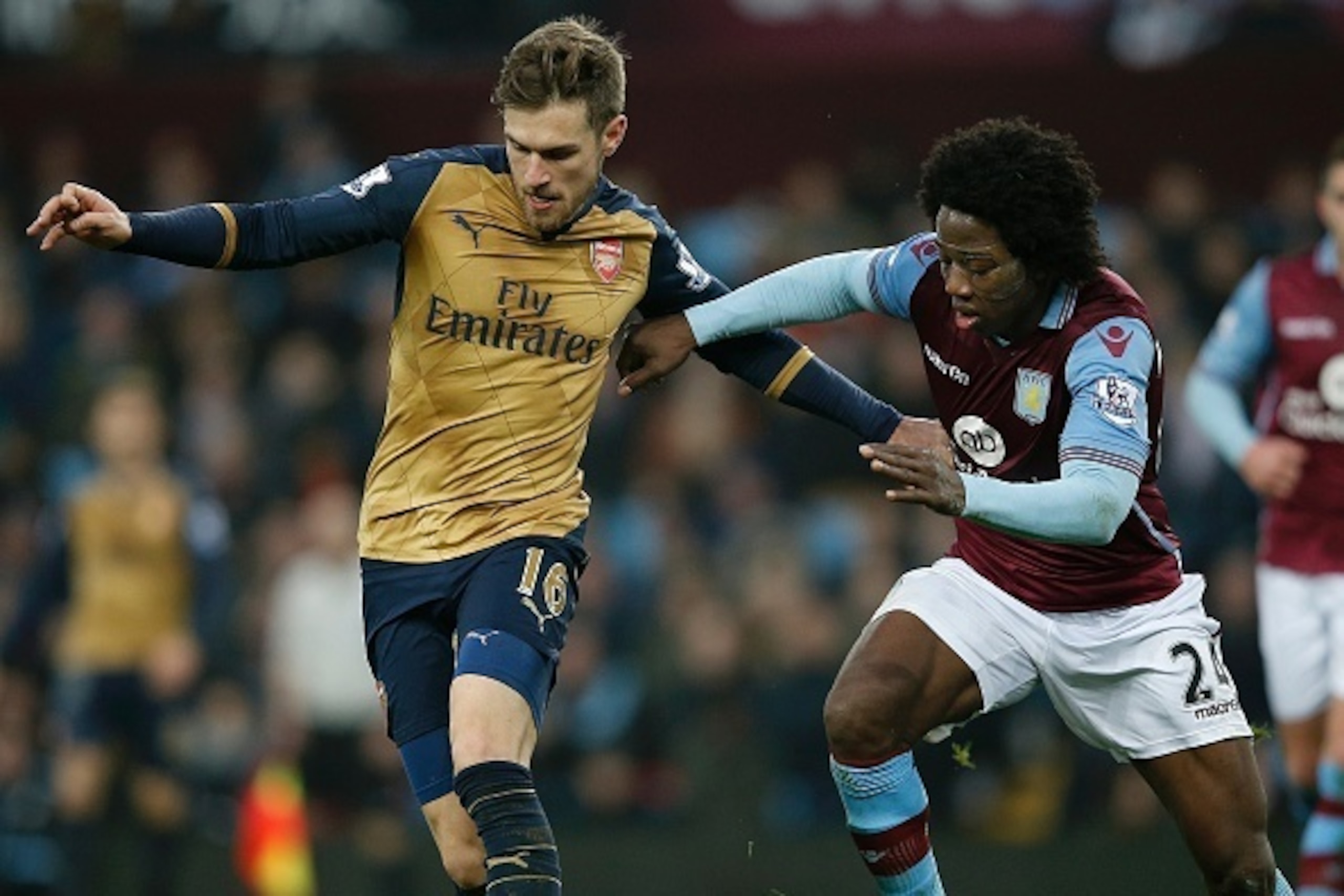Arsenal's Welsh midfielder Aaron Ramsey (L) vies with Aston Villa's Colombian midfielder Carlos Sanchez during the English Premier League football match between Aston Villa and Arsenal at Villa Park in Birmingham, central England on December 13, 2015.  AF