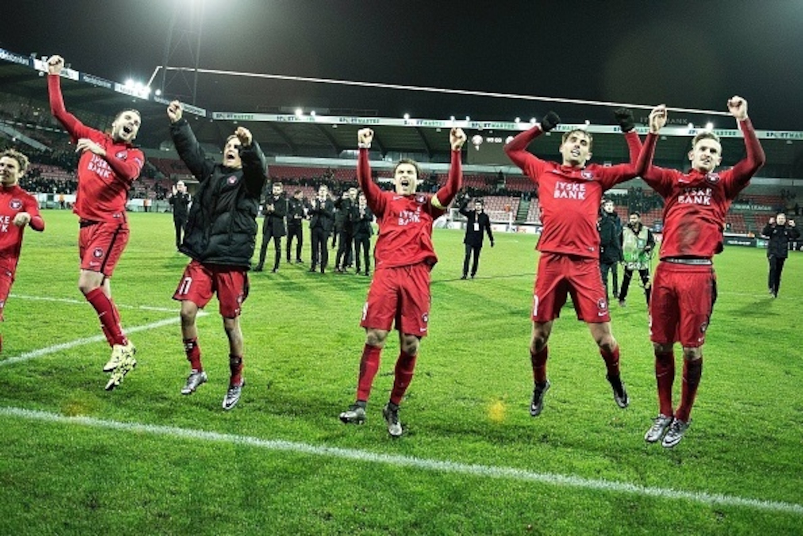 Players from FC Midtjylland celebrates after the match against Club Brugge during the UEFA Europa League group D football match between FC Midtjylland vs Club Brugge KV in Herning, Denmark on December 10, 2015.   AFP PHOTO / Scanpix Denmark / HENNING BAGG