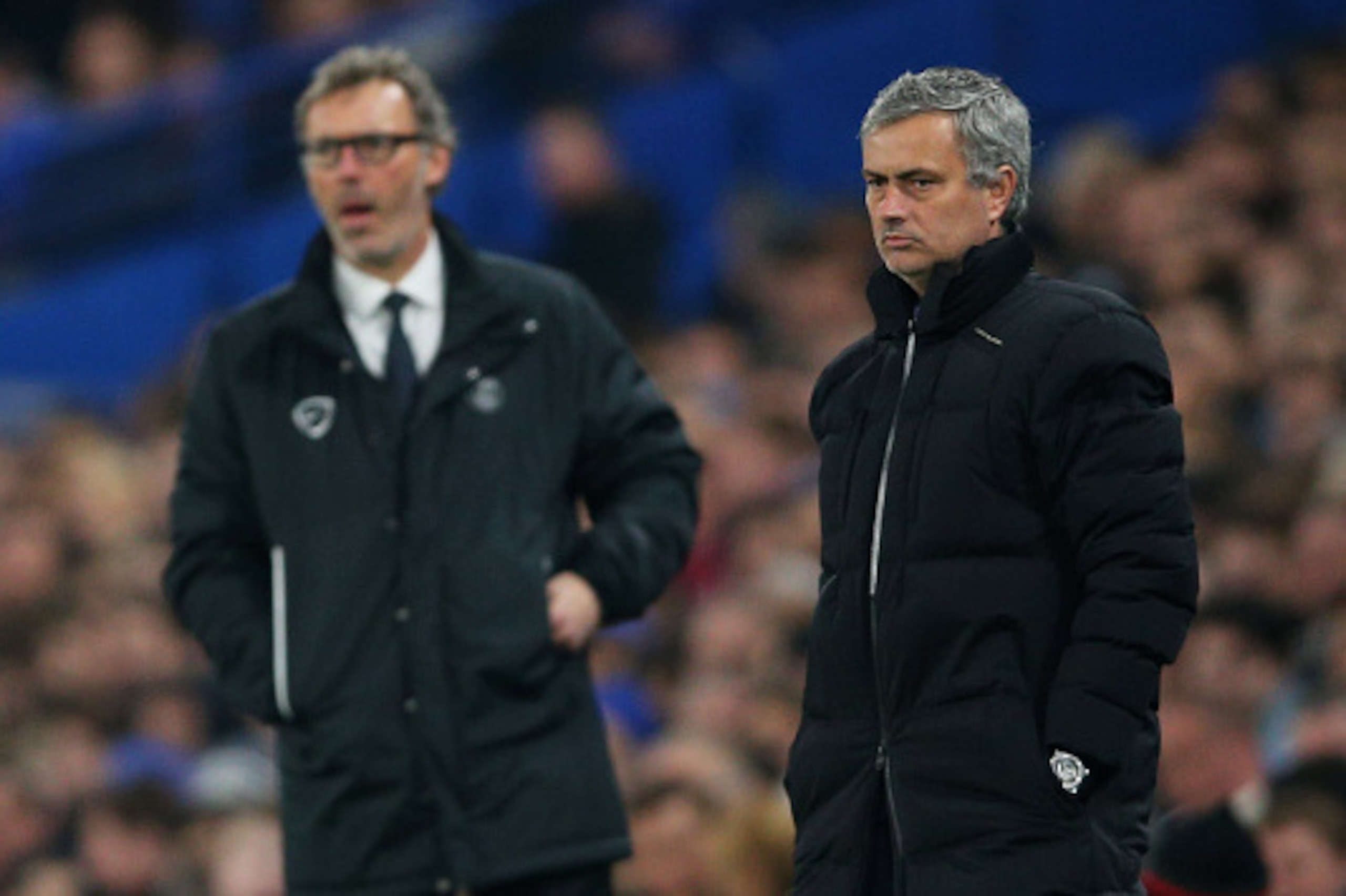LONDON, ENGLAND - MARCH 11:  Opposing managers Jose Mourinho (R) the manager of Chelsea and Laurent Blanc (L) the head coach of PSG look on during the UEFA Champions League Round of 16, second leg match between Chelsea and Paris Saint-Germain at Stamford 