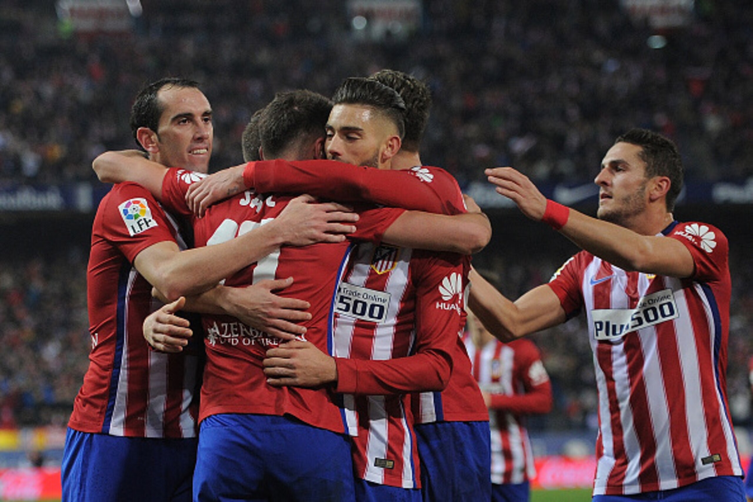 MADRID, SPAIN - DECEMBER 13:  Saul Niguez of Club Atletico de Madrid celebrates with Diego Godin after scoring his team's opening goal during the La Liga match between Club Atletico de Madrid and Athletic Club at Vicente Calderon Stadium on December 13, 2