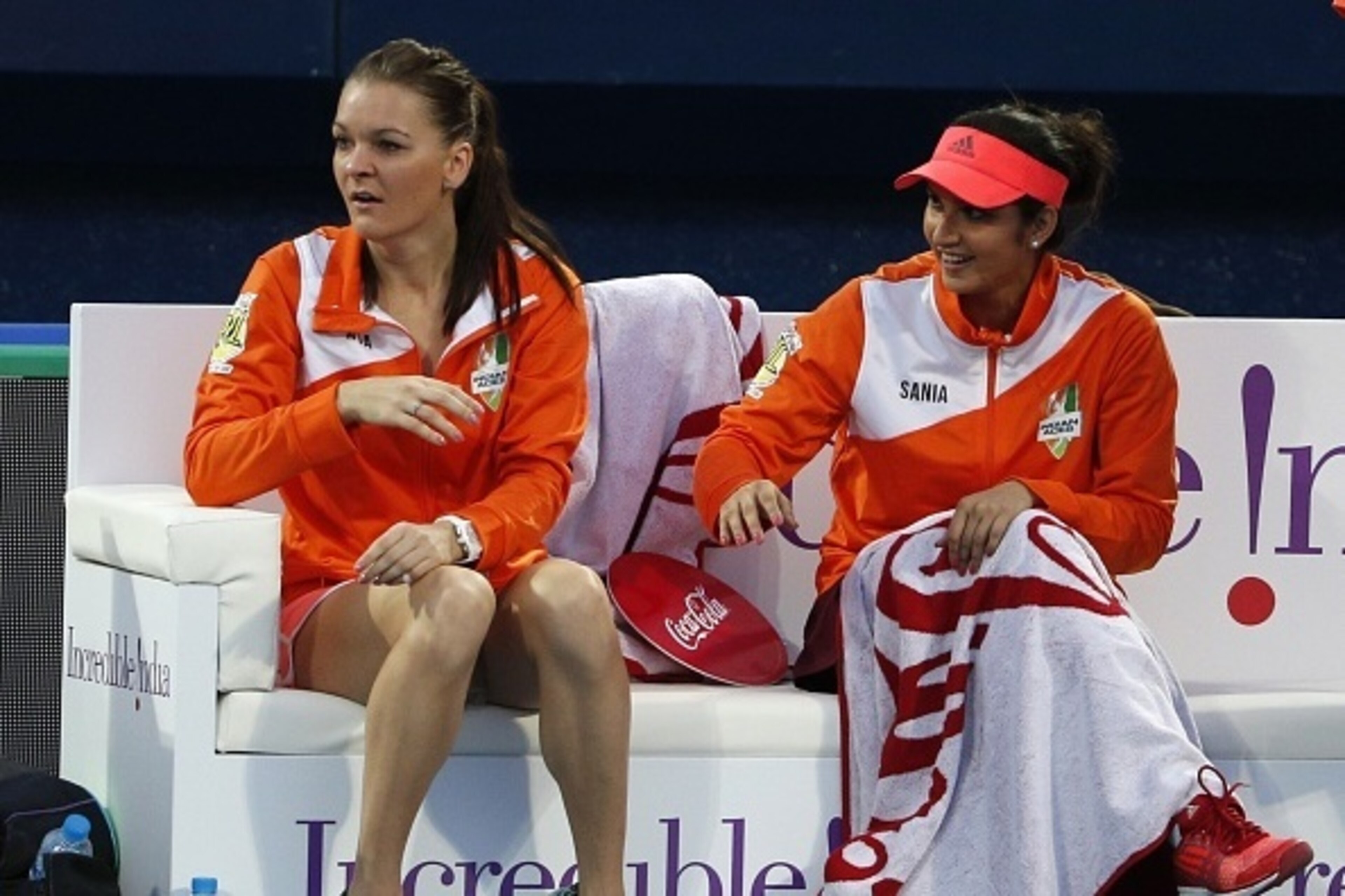 Indian Sania Mirza (R) and Agnieszka Radwanska of Micromax Indian Aces cheer during a tennis match between Frances Fabrice Santoro of Micromax Indian Aces and Sweden's Thomas Engvist of Legendari Japan Warriors during the part of the International Premier Indian Sania Mirza (R) and Agnieszka Radwanska of Micromax Indian Aces cheer during a tennis match between Frances Fabrice Santoro of Micromax Indian Aces and Sweden's Thomas Engvist of Legendari Japan Warriors during the part of the International Premier