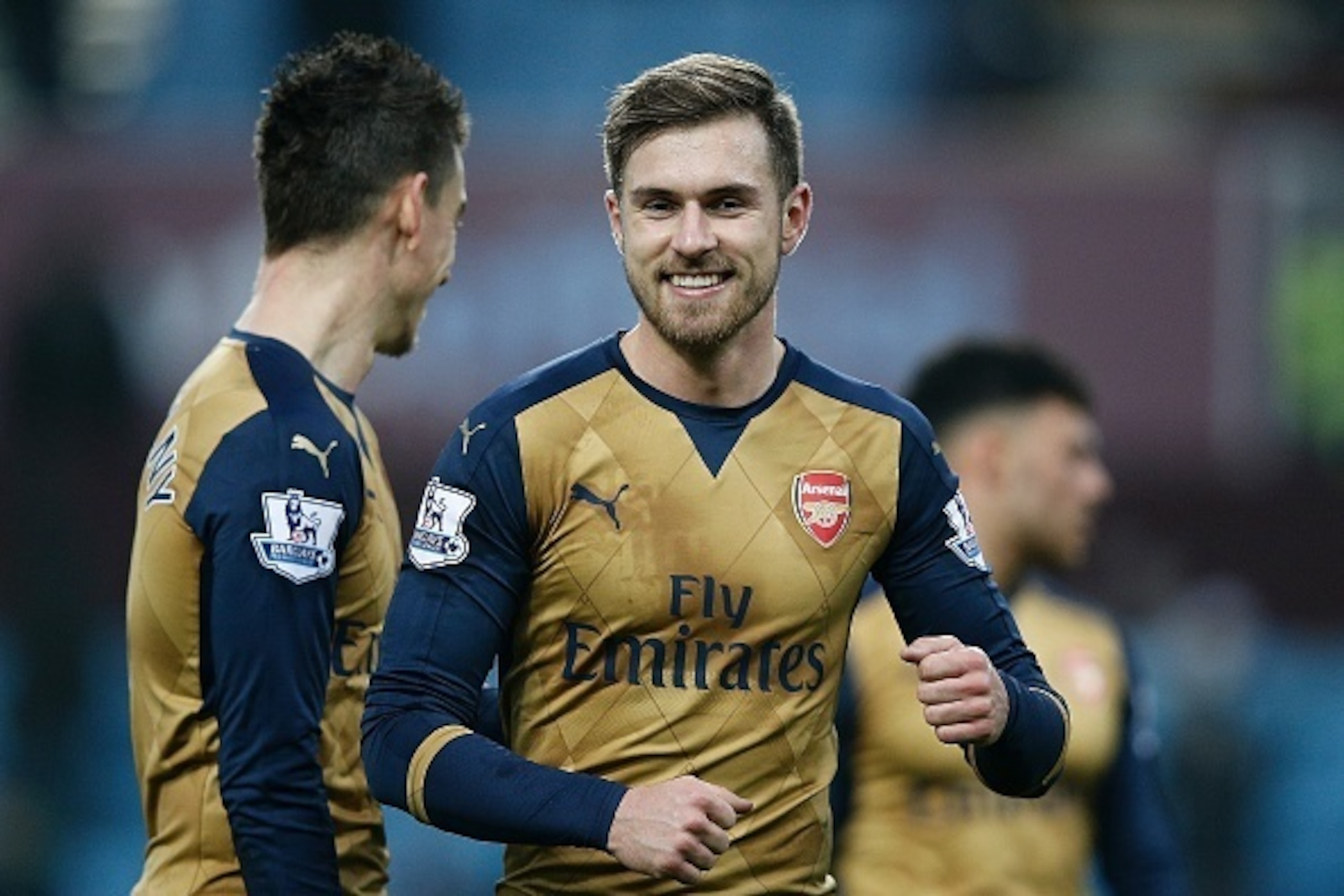 Arsenal's Welsh midfielder Aaron Ramsey (C) reacts following the English Premier League football match between Aston Villa and Arsenal at Villa Park in Birmingham, central England on December 13, 2015. Arsenal won the match 2-1.   AFP PHOTO / ADRIAN DENNI