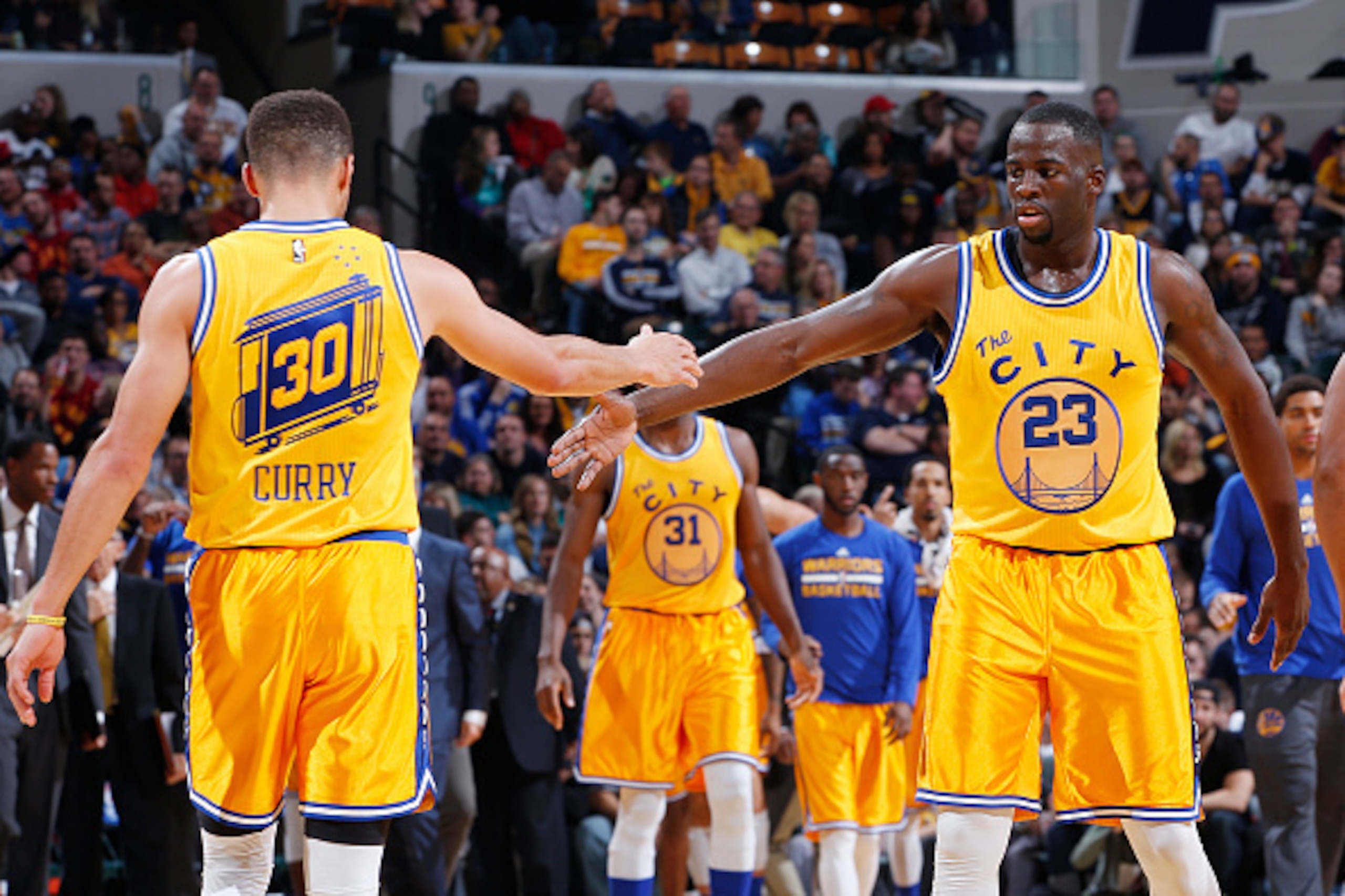 INDIANAPOLIS, IN - DECEMBER 8: Draymond Green #23 and Stephen Curry #30 of the Golden State Warriors celebrate against the Indiana Pacers in the second half of the game at Bankers Life Fieldhouse on December 8, 2015 in Indianapolis, Indiana. The Warriors 