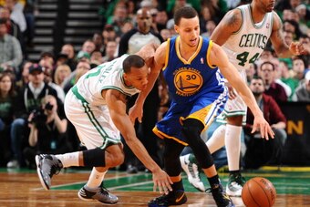 BOSTON, MA - MARCH 1:  Avery Bradley #0 of the Boston Celtics battles for a loose ball against Stephen Curry #30 of the Golden State Warriors on March 1, 2013 at the TD Garden in Boston, Massachusetts.  NOTE TO USER: User expressly acknowledges and agrees
