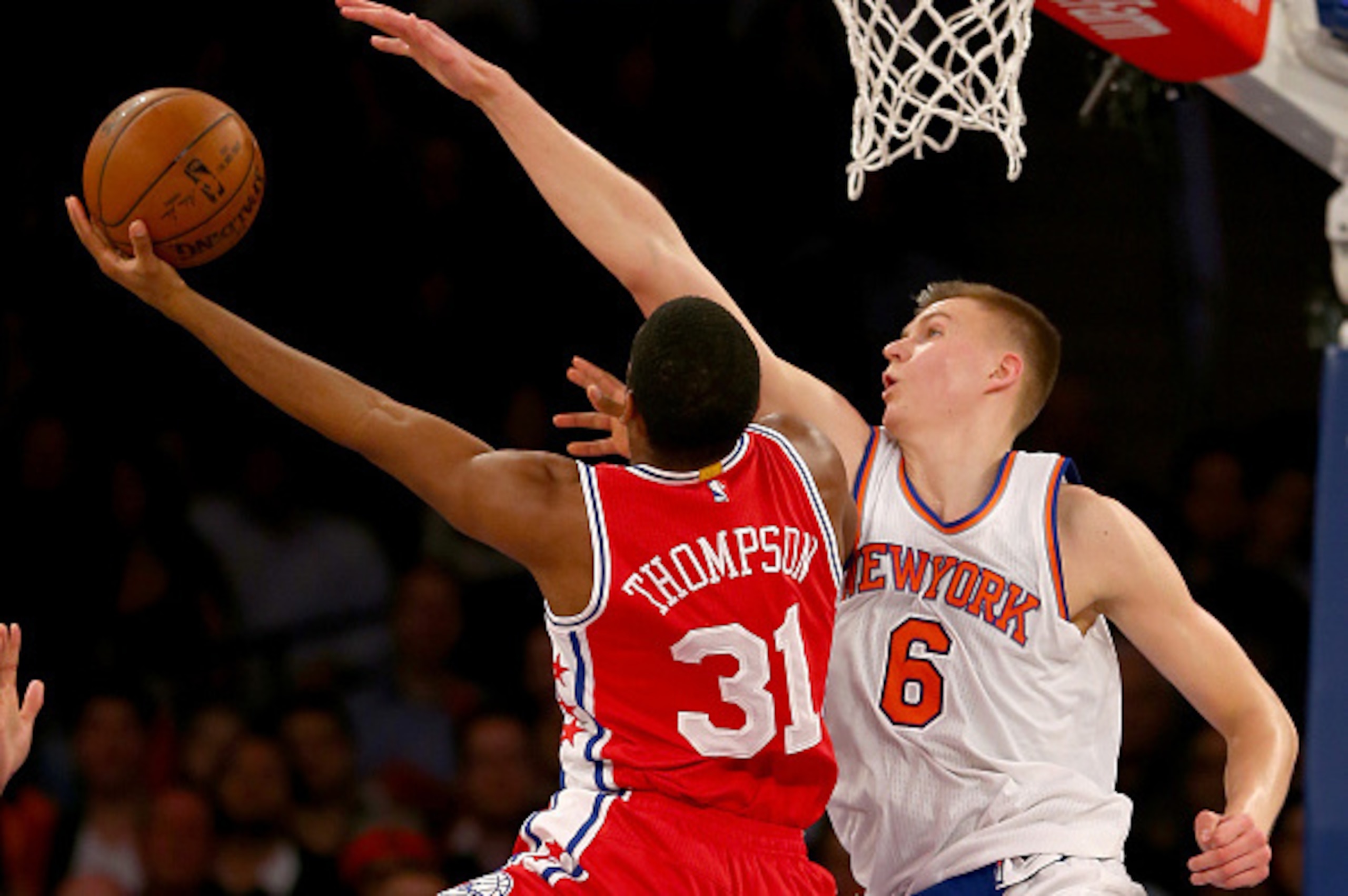 NEW YORK, NY - DECEMBER 02:  Hollis Thompson #31 of the Philadelphia 76ers heads for the net as Kristaps Porzingis #6 of the New York Knicks defends at Madison Square Garden on December 2, 2015 in New York City.The New York Knicks defeated the Philadelphi