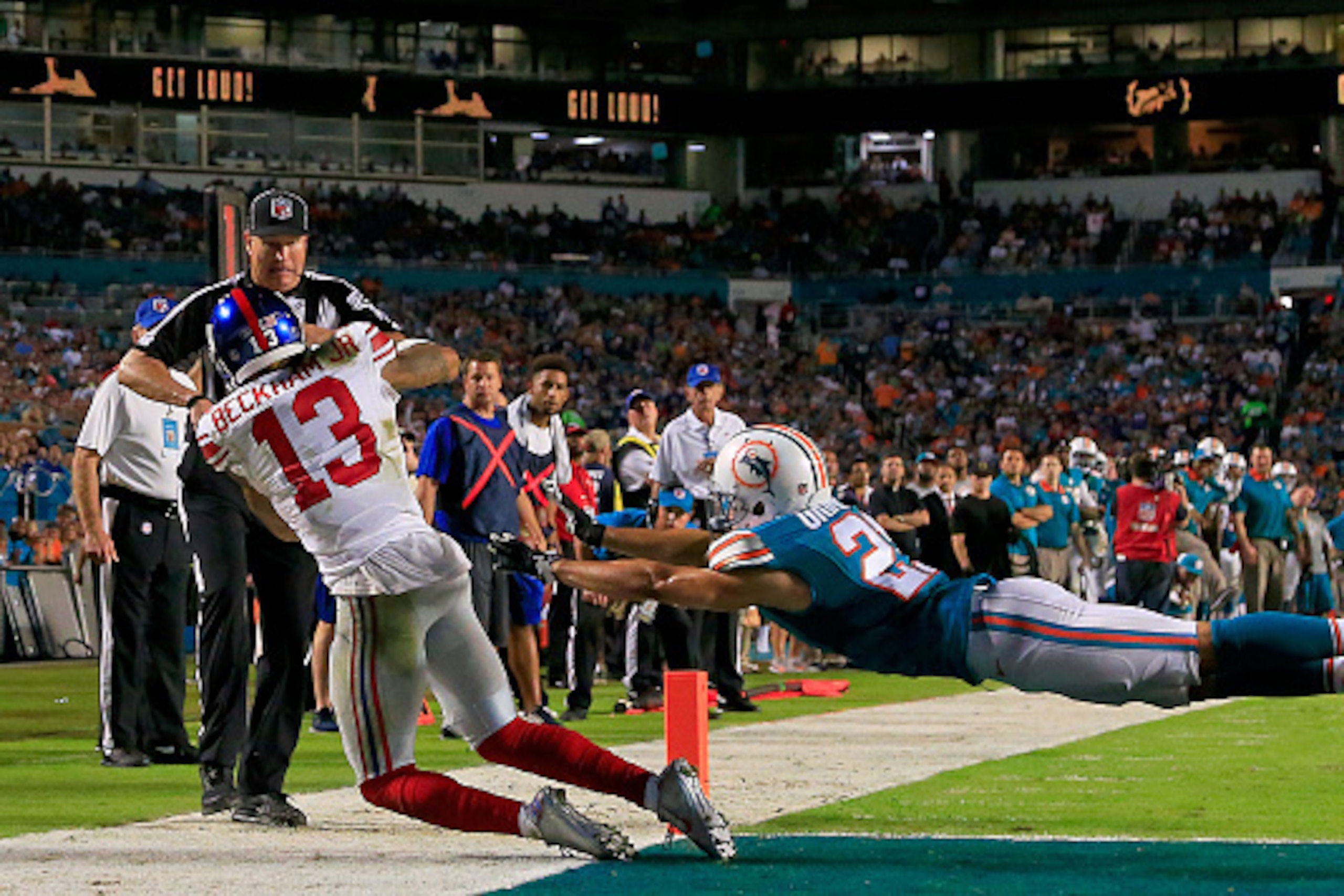 MIAMI GARDENS, FL - DECEMBER 14: Odell Beckham #13 of the New York Giants catches a touchdown pass as Brent Grimes #21 of the Miami Dolphins defends during the third quarter of the game at Sun Life Stadium on December 14, 2015 in Miami Gardens, Florida. MIAMI GARDENS, FL - DECEMBER 14: Odell Beckham #13 of the New York Giants catches a touchdown pass as Brent Grimes #21 of the Miami Dolphins defends during the third quarter of the game at Sun Life Stadium on December 14, 2015 in Miami Gardens, Florida.
