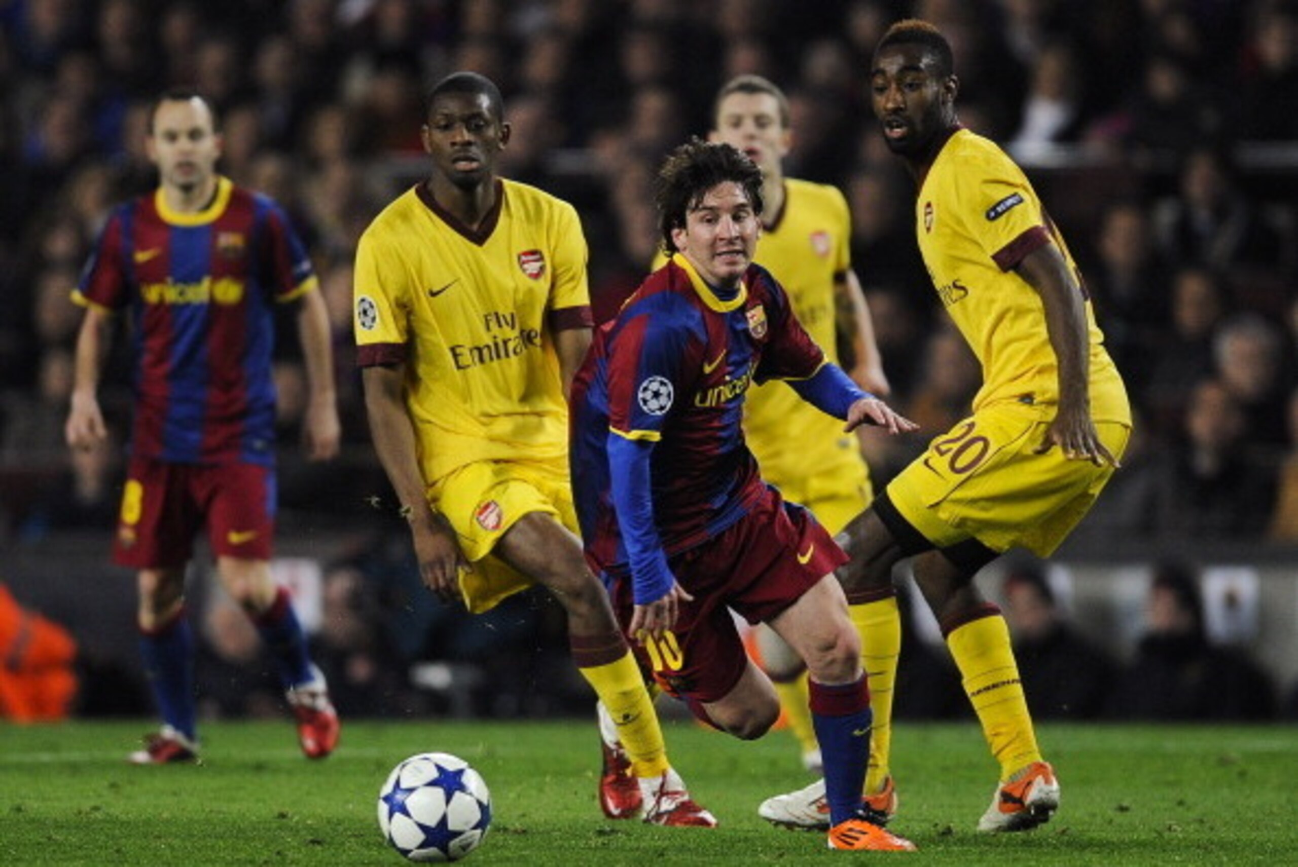 BARCELONA, SPAIN - MARCH 08: Lionel Messi of FC Barcelona (C) runs with the balls under a challenge by Abou Diaby (L) and Johan Djourou (R) of Arsenal during the UEFA Champions League round of 16 second leg match between Barcelona and Arsenal at the Camp BARCELONA, SPAIN - MARCH 08: Lionel Messi of FC Barcelona (C) runs with the balls under a challenge by Abou Diaby (L) and Johan Djourou (R) of Arsenal during the UEFA Champions League round of 16 second leg match between Barcelona and Arsenal at the Camp