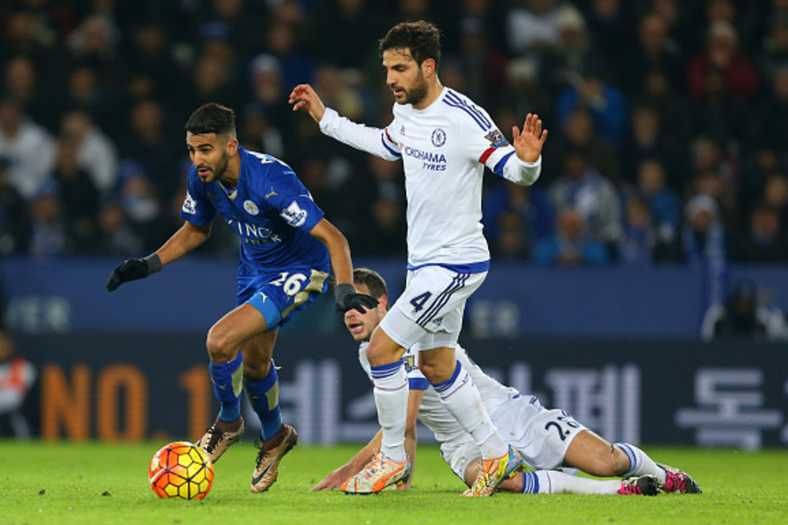 LEICESTER, ENGLAND - DECEMBER 14:  Riyad Mahrez of Leicester City gets away from Cesc Fabregas and Cesar Azpilicueta of Chelsea during the Barclays Premier League match between Leicester City and Chelsea at the King Power Stadium on December 14, 2015 in L