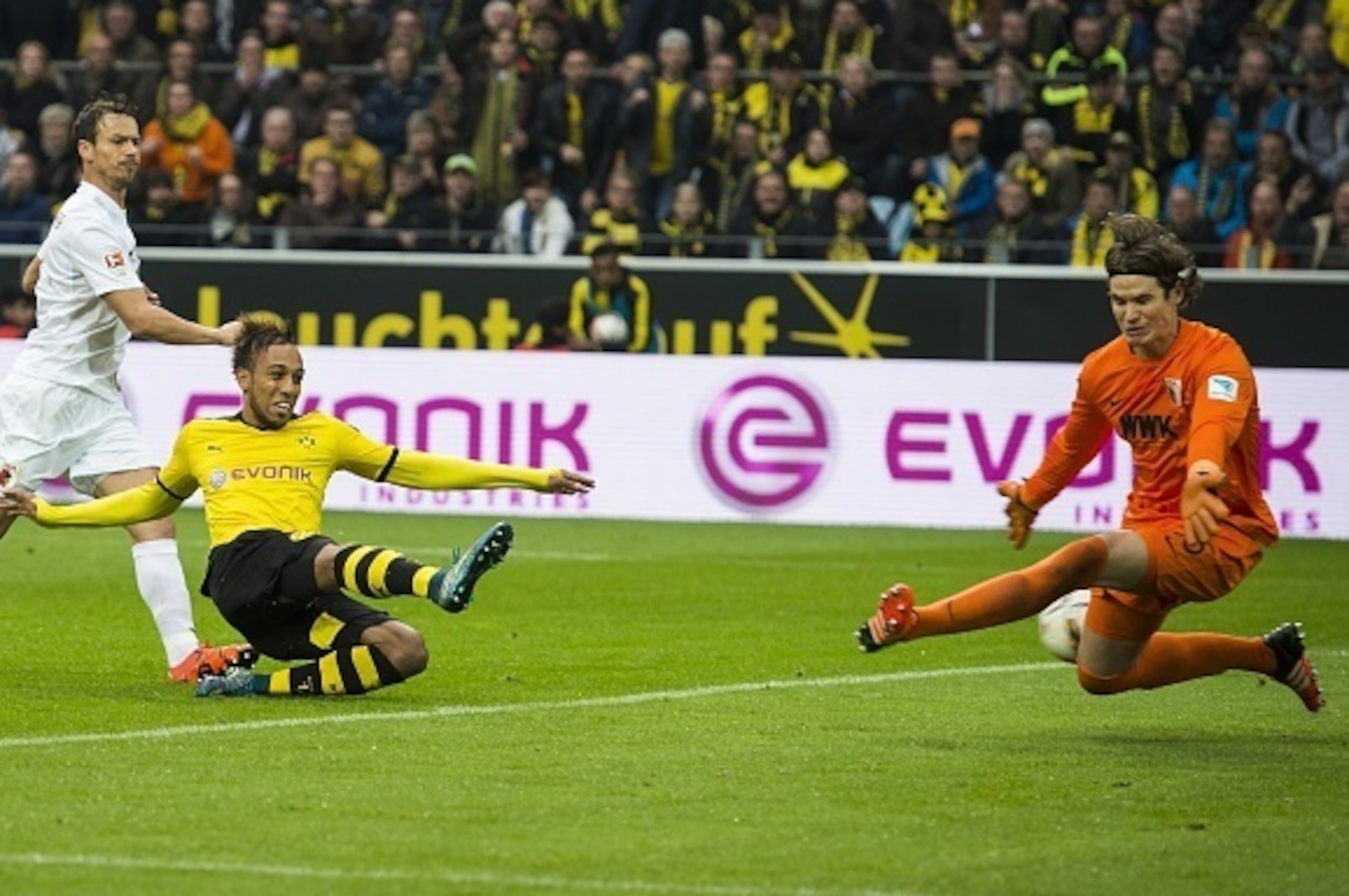 Dortmund's Gabonese midfielder Pierre-Emerick Aubameyang (2nd, L) has a shot blocked by Augsburg's Swiss goalkeeper Marwin Hitz (R)  during the German first division football Bundesliga match between Borussia Dortmund and FC Augsburg on October 25, 2015 i