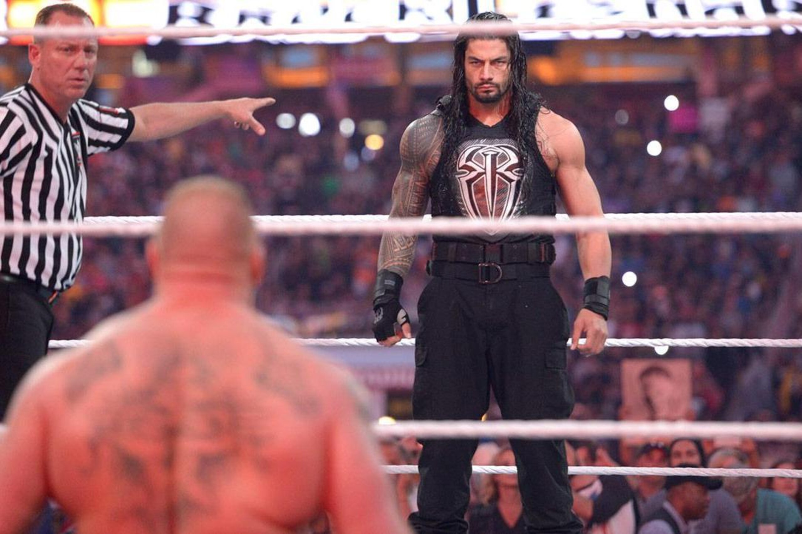 Brock Lesnar and Roman Reigns stare each other down at WrestleMania 31.
