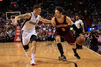 MIAMI, FL - DECEMBER 05:  Matthew Dellavedova #8 of the Cleveland Cavaliers dribbles the ball under pressure from Tyler Johnson #8 of the Miami Heat at American Airlines Arena on December 5, 2015 in Miami, Florida. NOTE TO USER: User expressly acknowledge