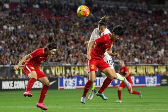GLENDALE, AZ - DECEMBER 13:  Carli Lloyd #10 of the United States attempts a header over Li Dongna #6 of China during the second half of the women's soccer match at University of Phoenix Stadium on December 13, 2015 in Glendale, Arizona. USA defeated Chin
