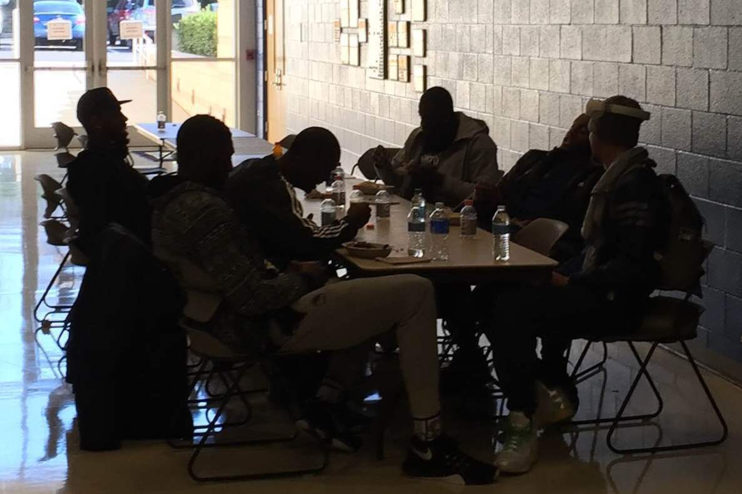 Jason Thompson, Festus Ezeli, Harrison Barnes, Draymond Green, Andre Iguodala and Stephen Curry (left to right) at their makeshift lunch table, eating Chipotle and laughing, outside the gym at Johnson & Wales University in Charlotte.