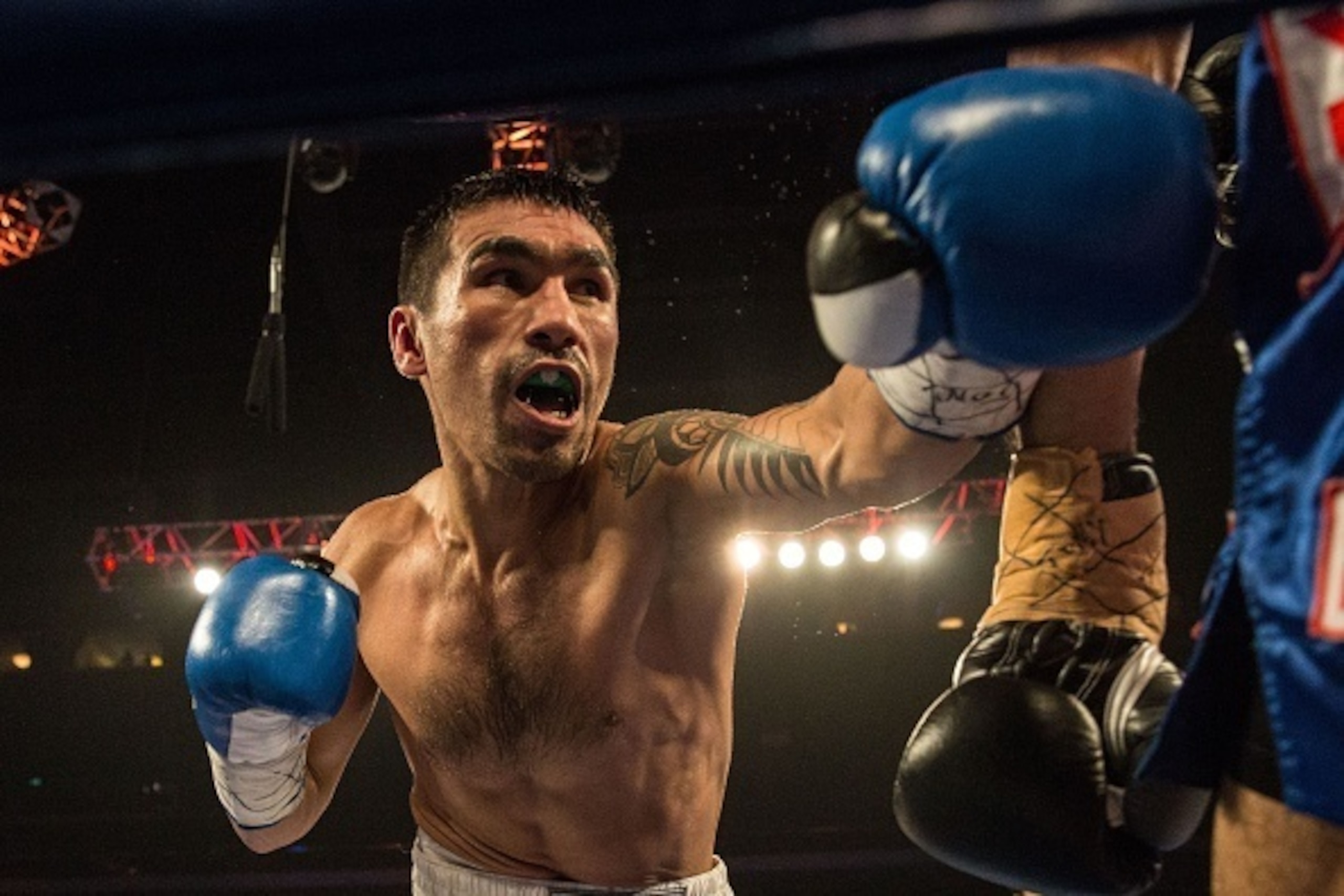 Denis Shafikov of Russia (L) punches Indonesia's Roy Mukhlis (R) during their lightweight ten round boxing bout at the Venetian's Cotai Arena in Macau on July 18, 2015. AFP PHOTO / ANTHONY WALLACE        (Photo credit should read ANTHONY WALLACE/AFP/Getty