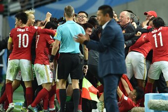 China's Guangzhou Evergrande head coach Luiz Felipe Scolari (3R) and players celebrate after midfielder Paulinho scored the winning goal against Mexico's Club America during their Club World Cup quarter-final football match in Osaka on December 13, 2015. 