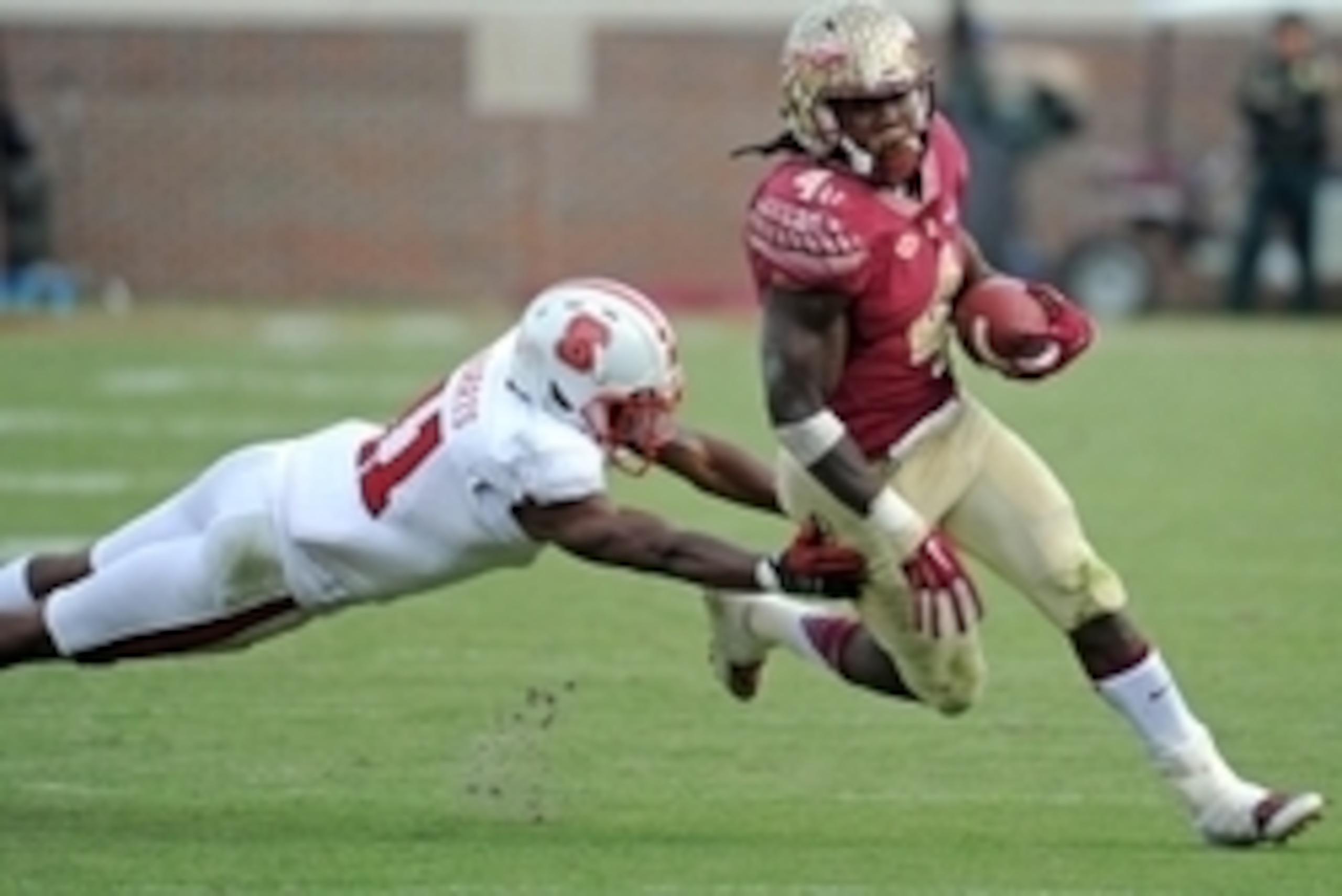 Nov 14, 2015; Tallahassee, FL, USA; Florida State Seminoles running back Dalvin Cook (4) runs the ball past North Carolina State Wolfpack cornerback Juston Burris (11) during the second half of the game at Doak Campbell Stadium. Mandatory Credit: Melina V