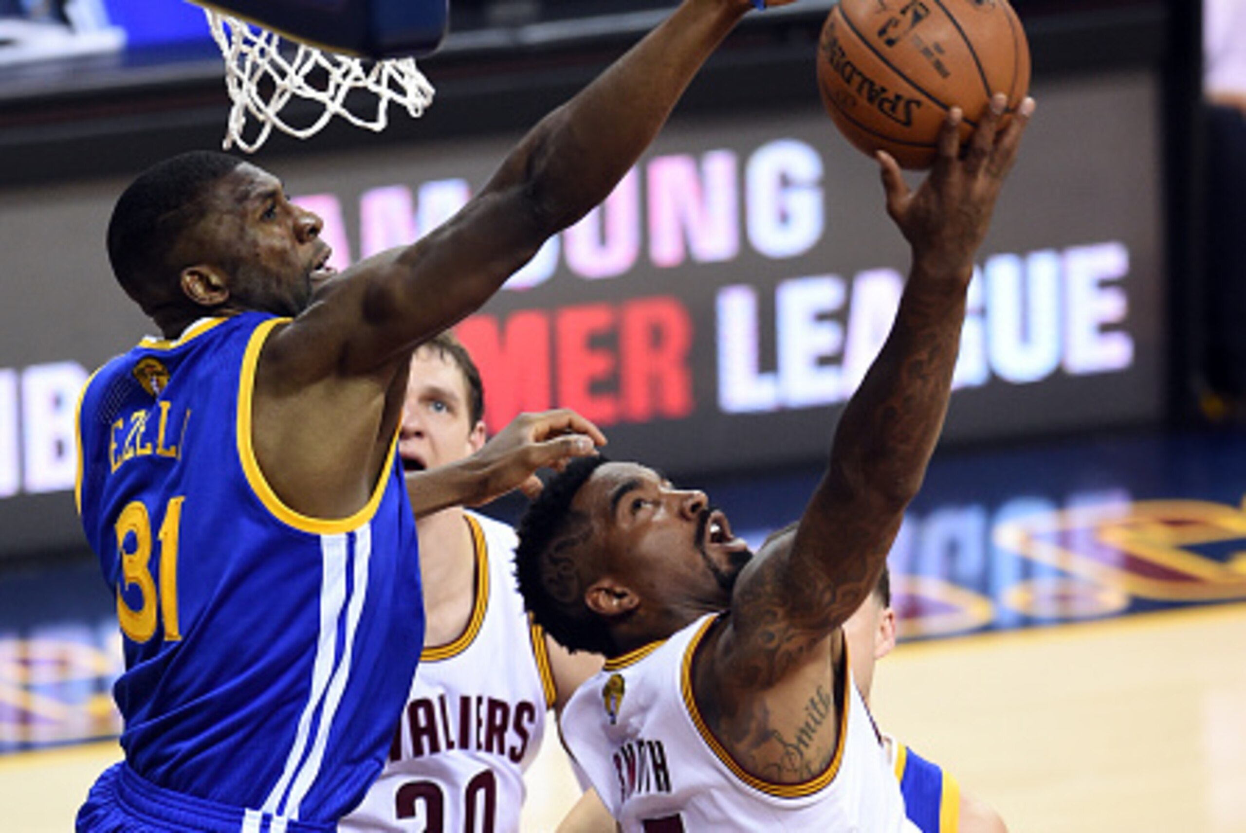 CLEVELAND, OH - JUNE 16:  J.R. Smith #5 of the Cleveland Cavaliers goes up against Festus Ezeli #31 of the Golden State Warriors during Game Six of the 2015 NBA Finals at Quicken Loans Arena on June 16, 2015 in Cleveland, Ohio. NOTE TO USER: User expressl