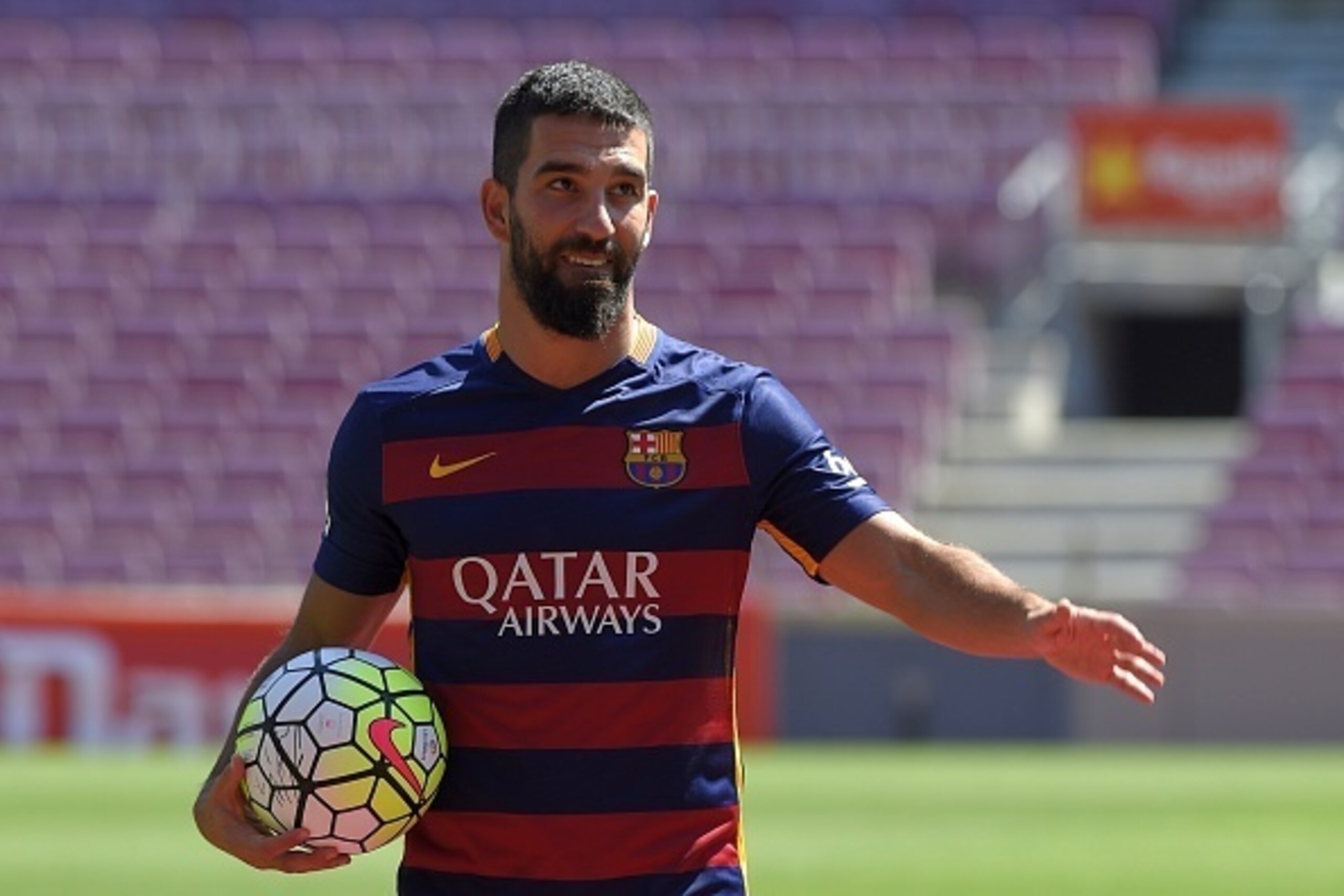 Barcelona's new player Turkish Arda Turan gestures during his official presentation at the Camp Nou stadium in Barcelona, after signing his new contract with the Catalan club, on July 10, 2015. Barcelona will keep more than 60 million euros ($65 million) 