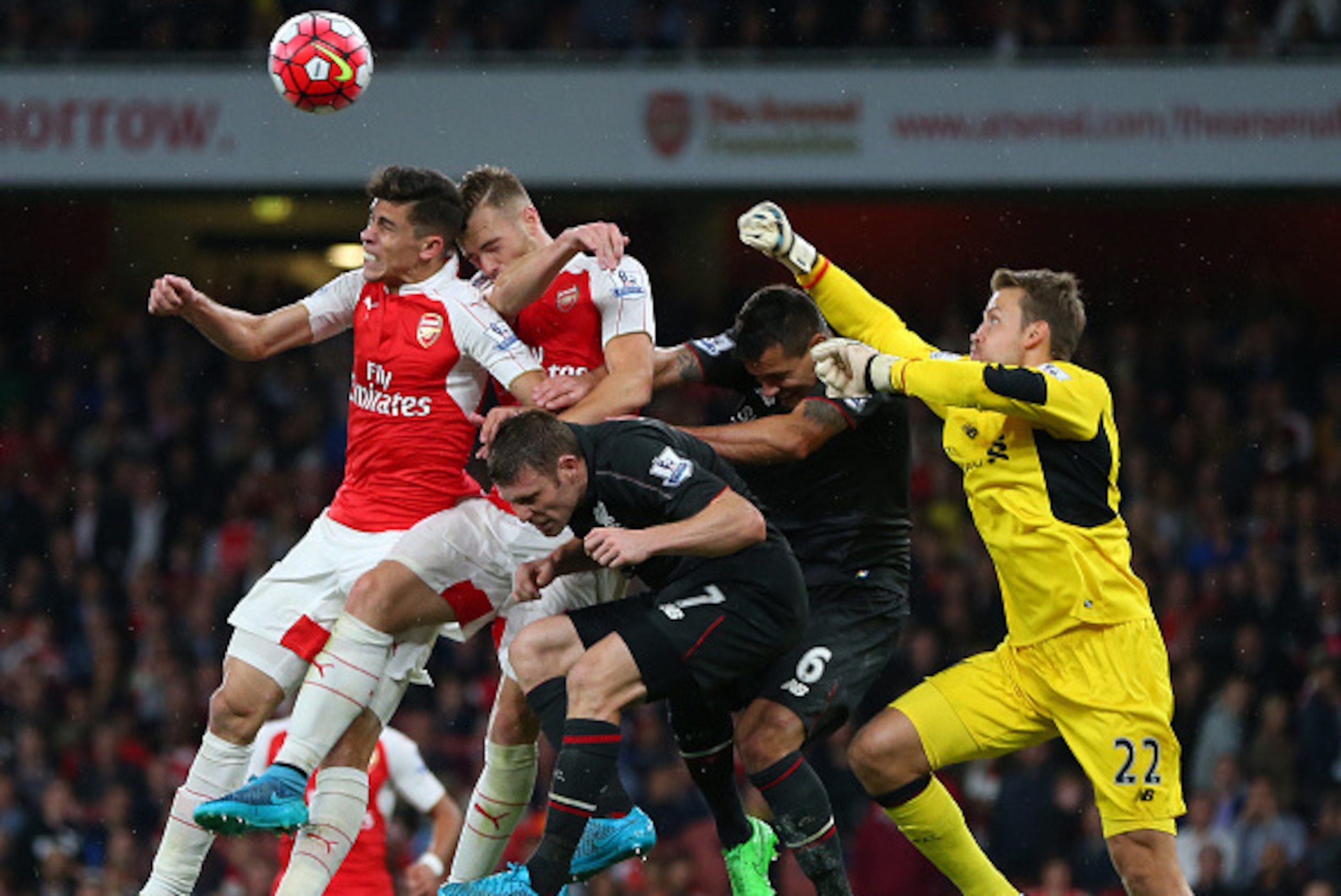 LONDON, ENGLAND - AUGUST 24: Liverpool goalkeeper Simon Mignolet punches away a last minute shot as he gets caught up with Gabriel Paulista, Calum Chambers of Arsenal along with James Milner and Dejan Lovren of Liverpool during the Barclays Premier Leagu LONDON, ENGLAND - AUGUST 24: Liverpool goalkeeper Simon Mignolet punches away a last minute shot as he gets caught up with Gabriel Paulista, Calum Chambers of Arsenal along with James Milner and Dejan Lovren of Liverpool during the Barclays Premier Leagu