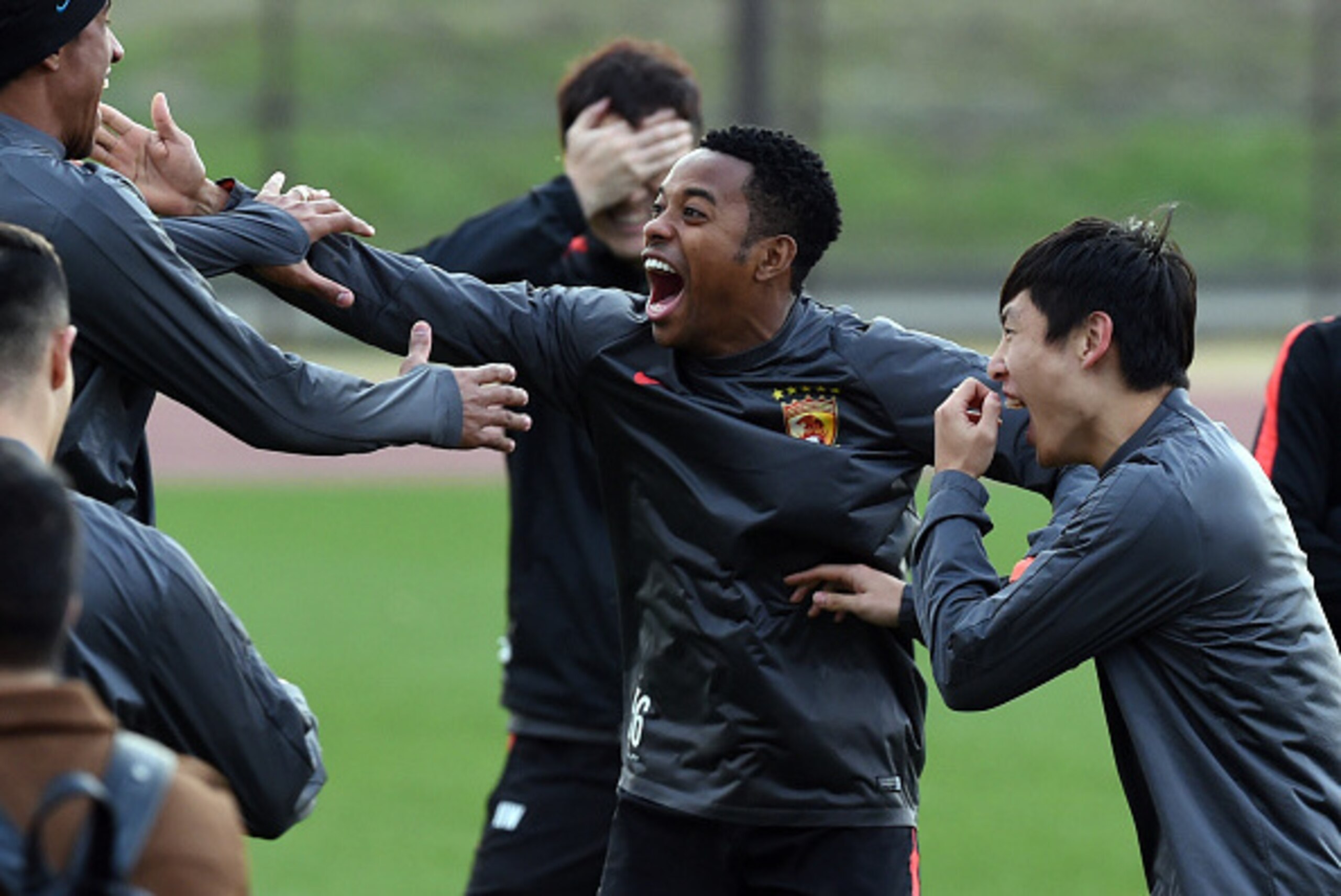 Guangzhou Evergrande forward Robinho (2nd R) celebrates with teammates during a team training session for the Club World Cup football tournament in Yokohama on December 15, 2015. Asian champions Guangzhou Evergrande of China will play against Barcelona in
