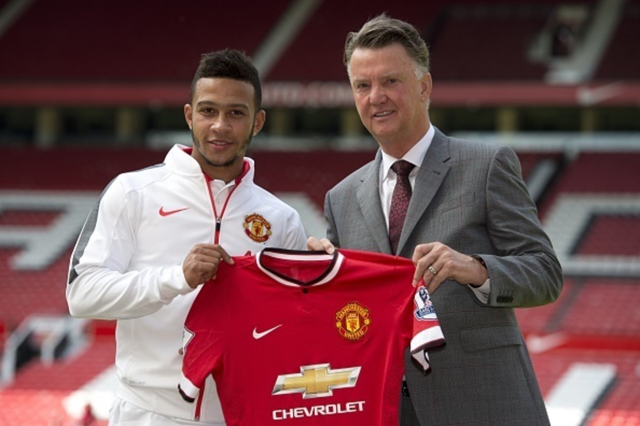 Dutch midfielder Memphis Depay (L) poses for a photograph with Manchester United's Dutch manager Louis van Gaal as he is officially unveiled as a Manchester United player at Old Trafford stadium in Manchester, north west England on July 10, 2015. Manchest